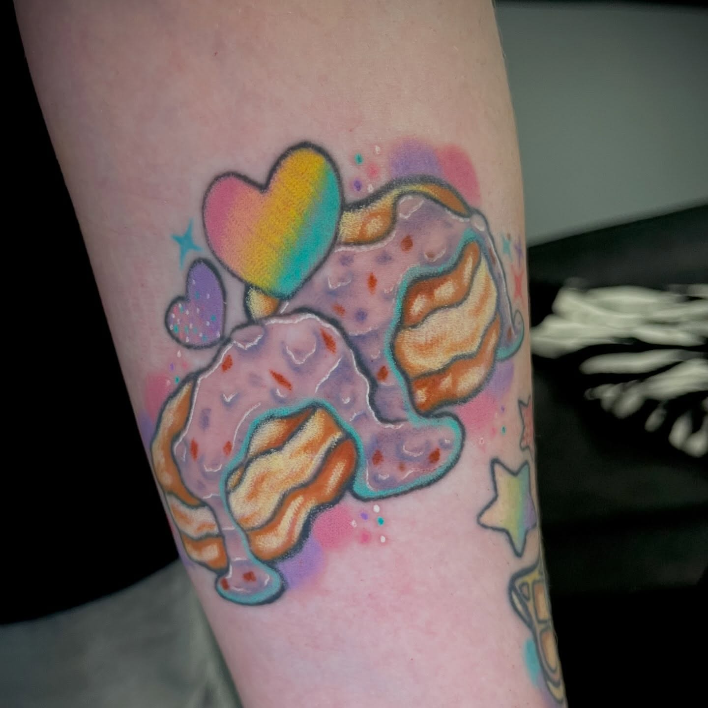 Ice cream cone watercolor tattoo on the forearm by Ash Wheeler