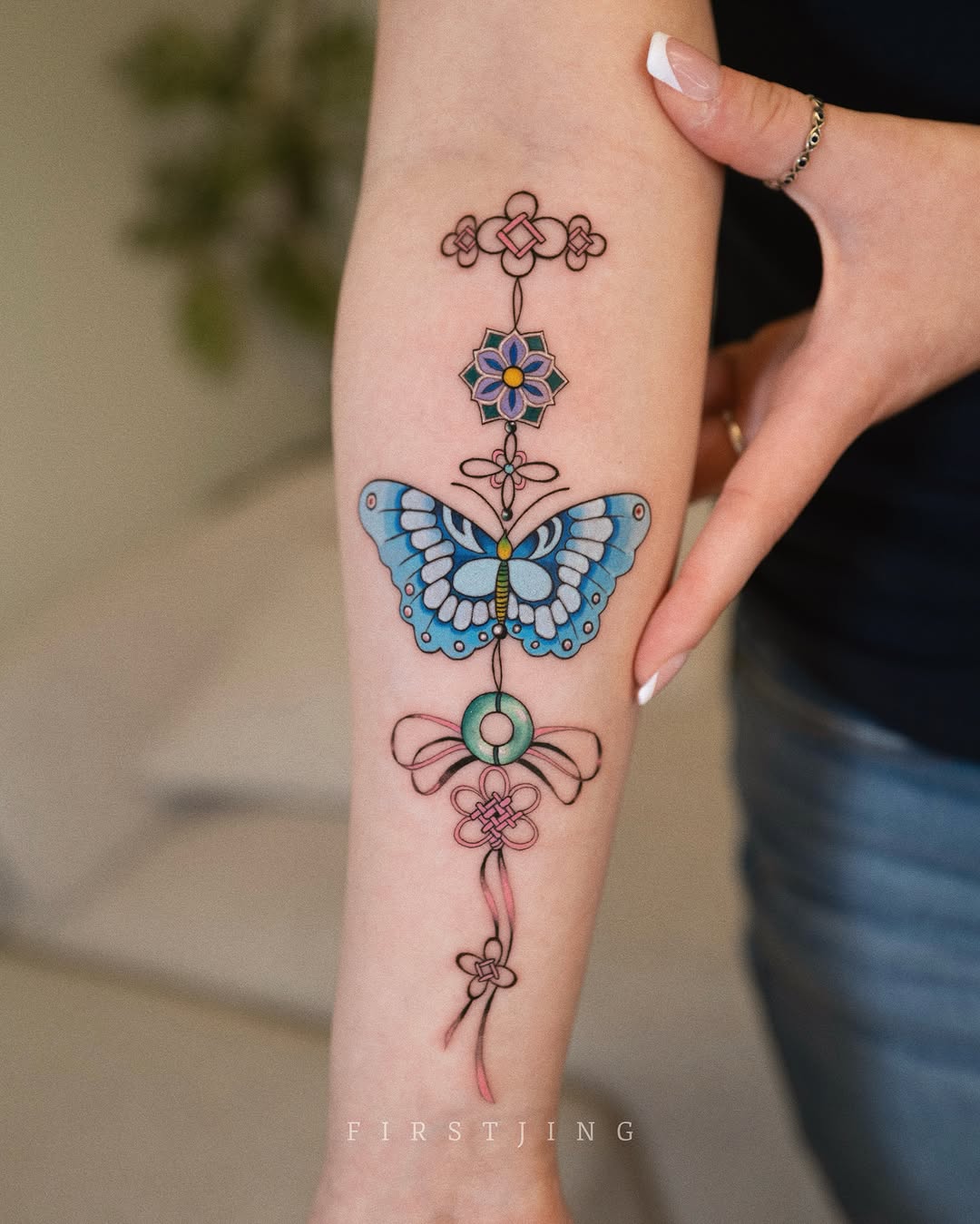 Butterfly and knotwork fine line tattoo on the forearm by Seattle