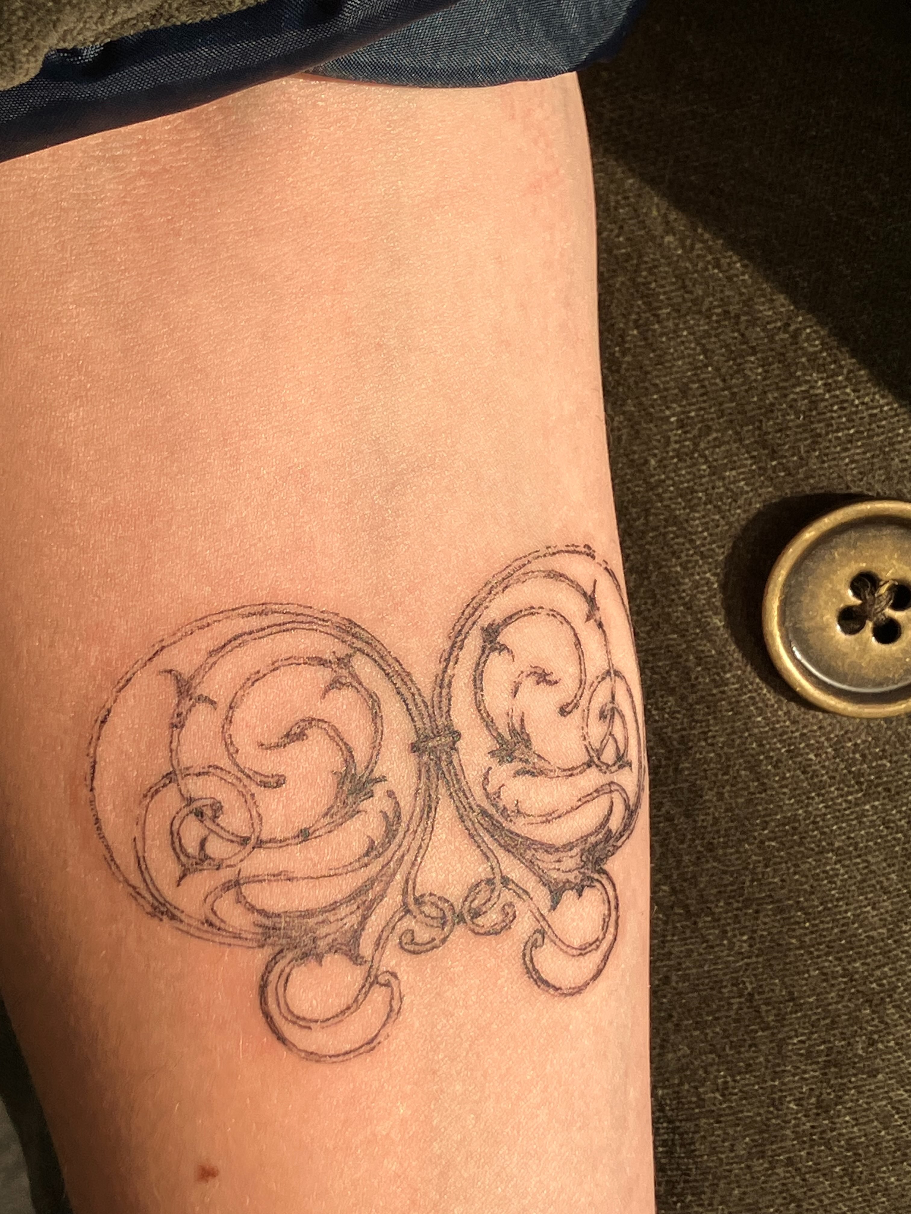 Scrollwork ornamental tattoo on the forearm by Sashka