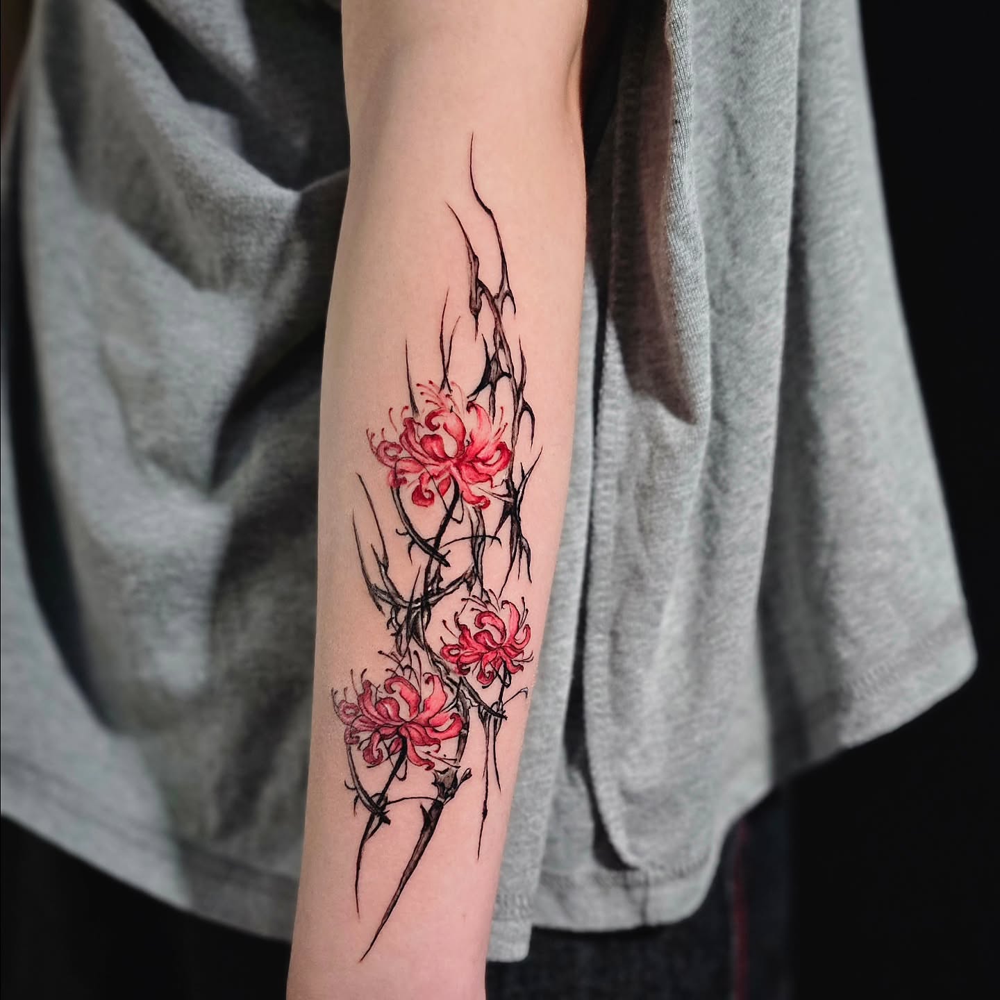 Chrysanthemums watercolor tattoo on the forearm by Lili Gu