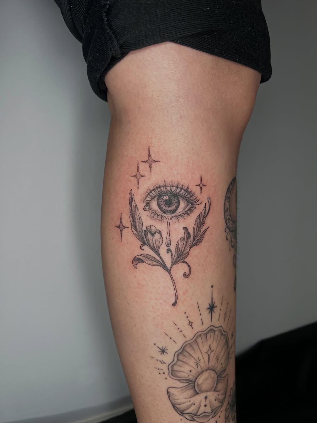 Eye with tear and floral elements ornamental tattoo on the forearm by ๐ฆ๐๐๐ก ๐ฆ๐๐๐