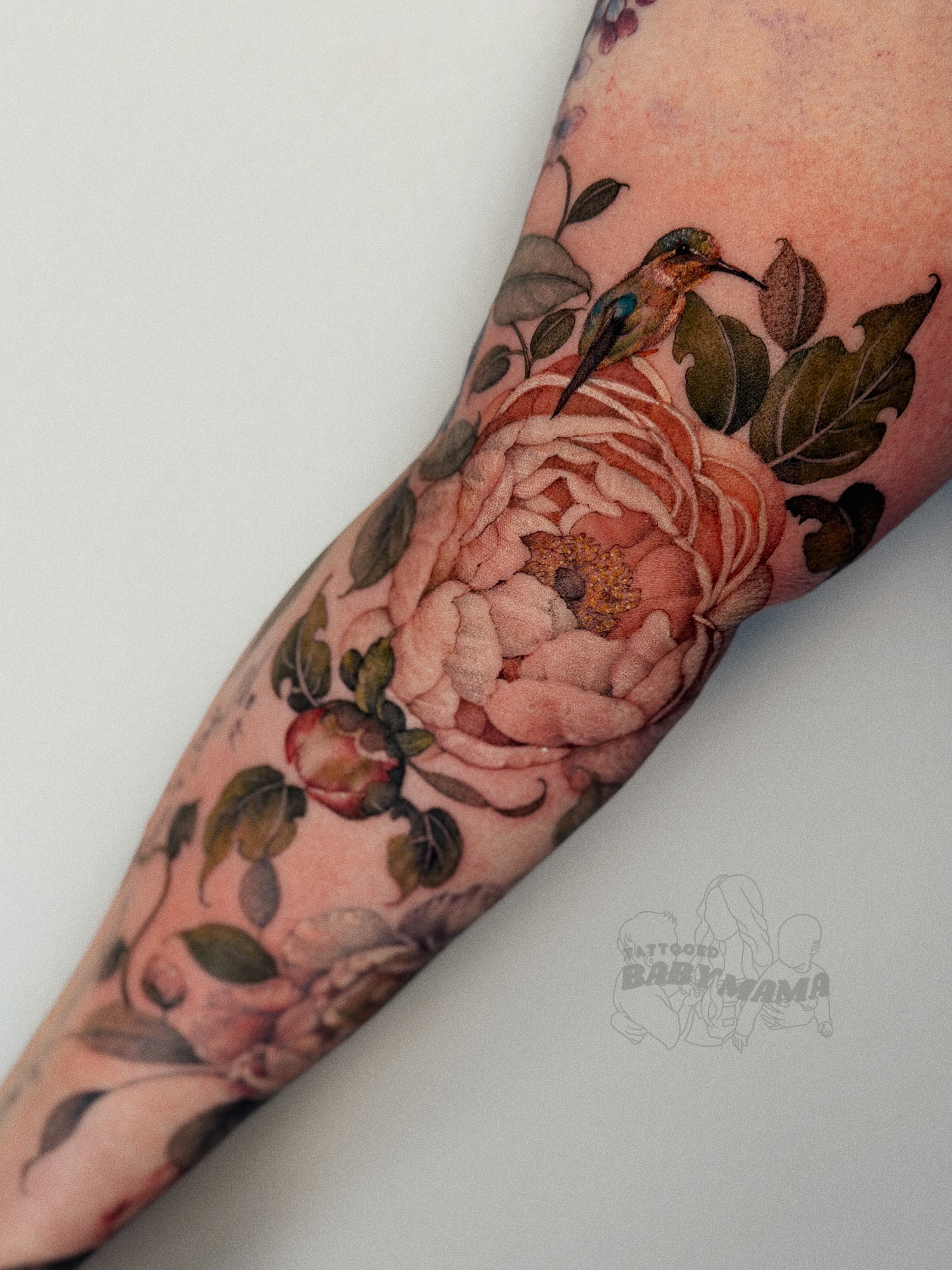 Peony and hummingbird realism tattoo on the forearm by Andrea Evangelista