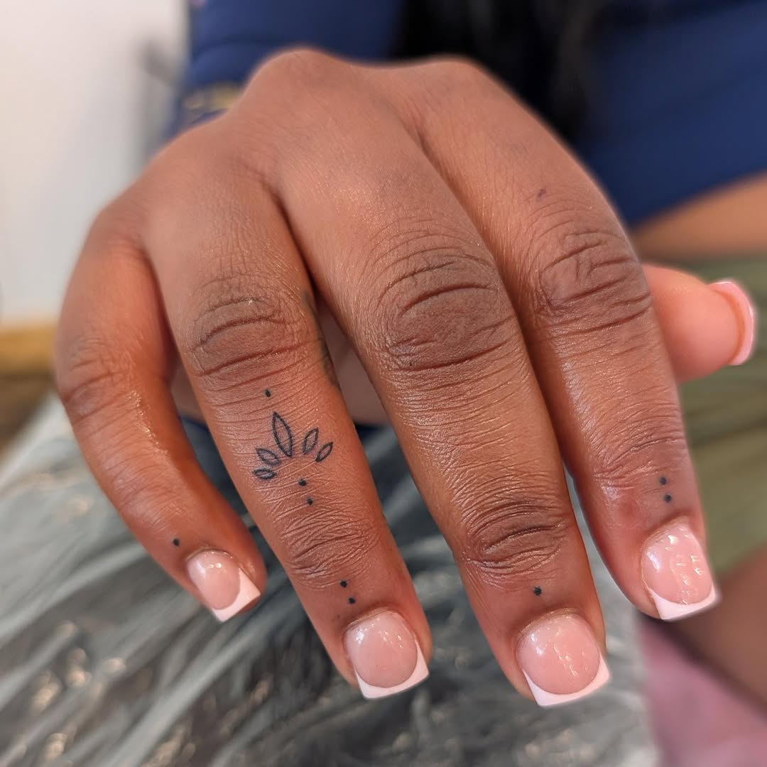 Lotus flower and dots dotwork tattoo on the hand by Nenookaasi Martin