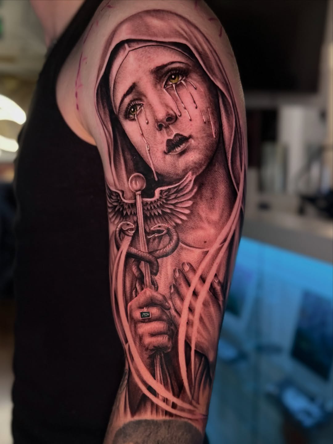 Crying woman with caduceus Chicano tattoo on the forearm by Denver Tattoo Artist