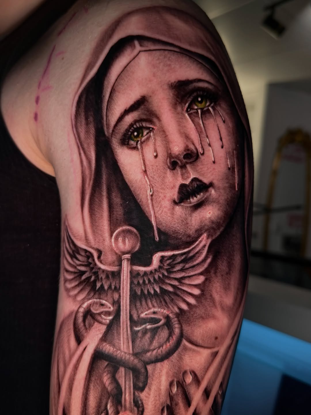 Crying woman with caduceus Chicano tattoo on the forearm by Denver Tattoo Artist