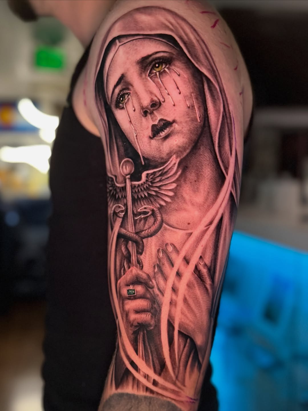Crying woman with caduceus Chicano tattoo on the forearm by Denver Tattoo Artist
