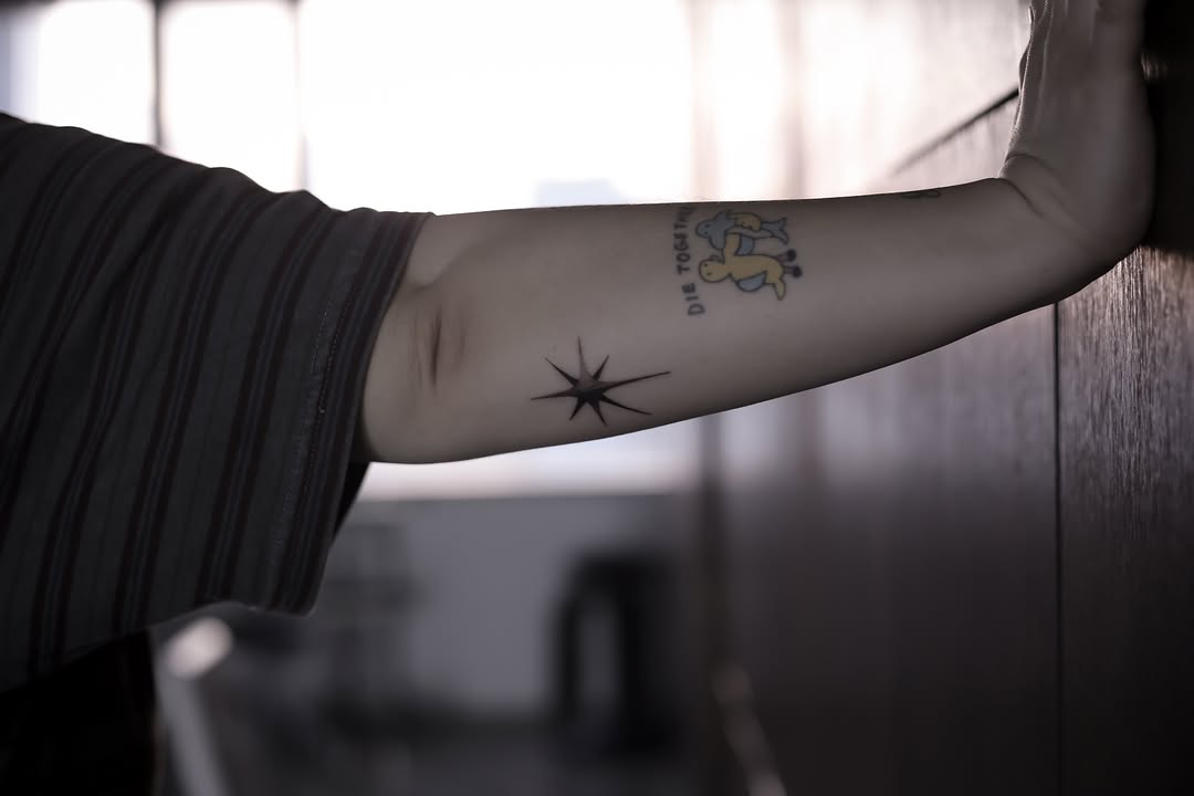 Star and cartoon figures minimalist tattoo on the forearm by Blight