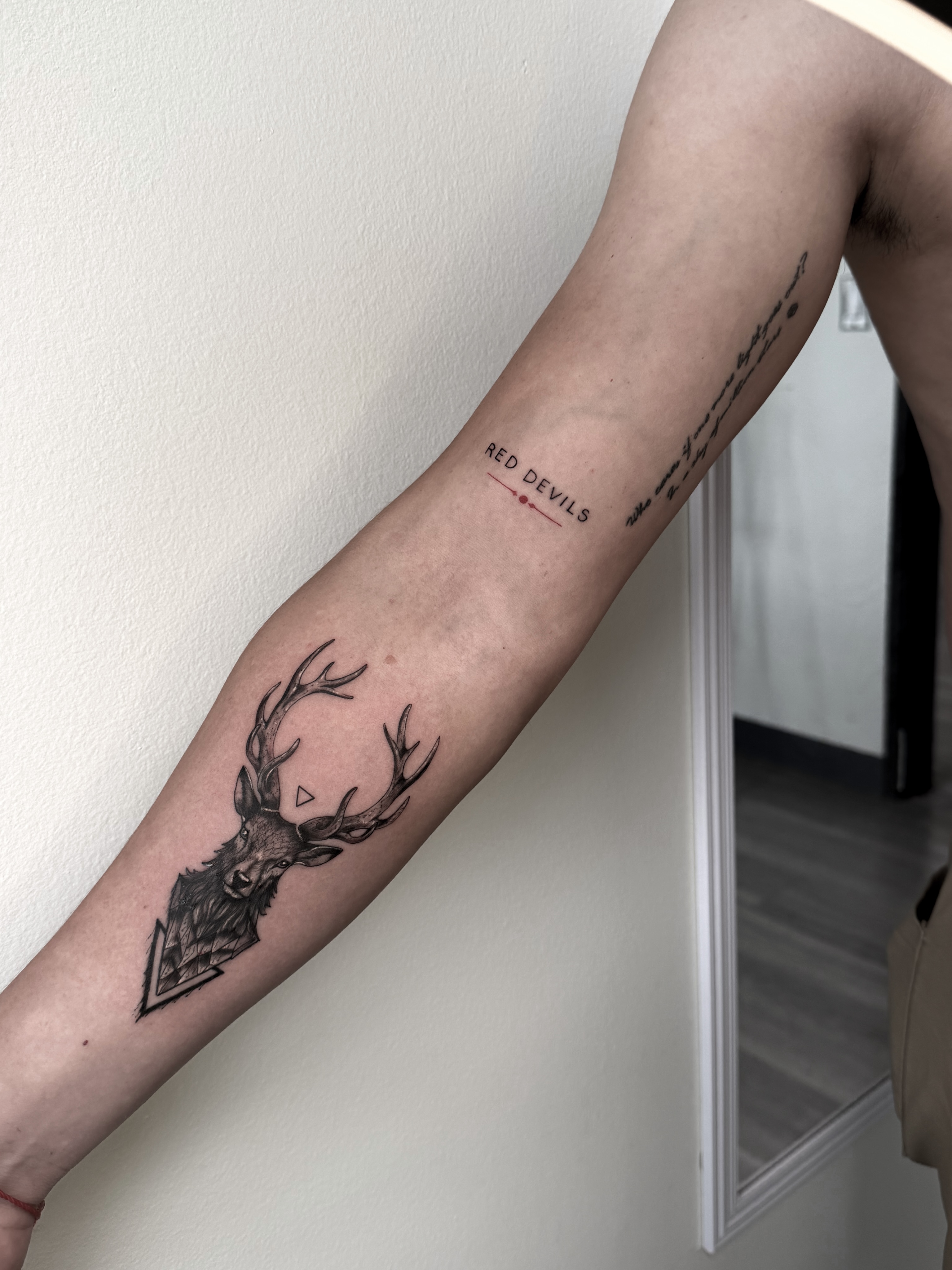 Stag head realism tattoo on the forearm by Tatuajes Denver