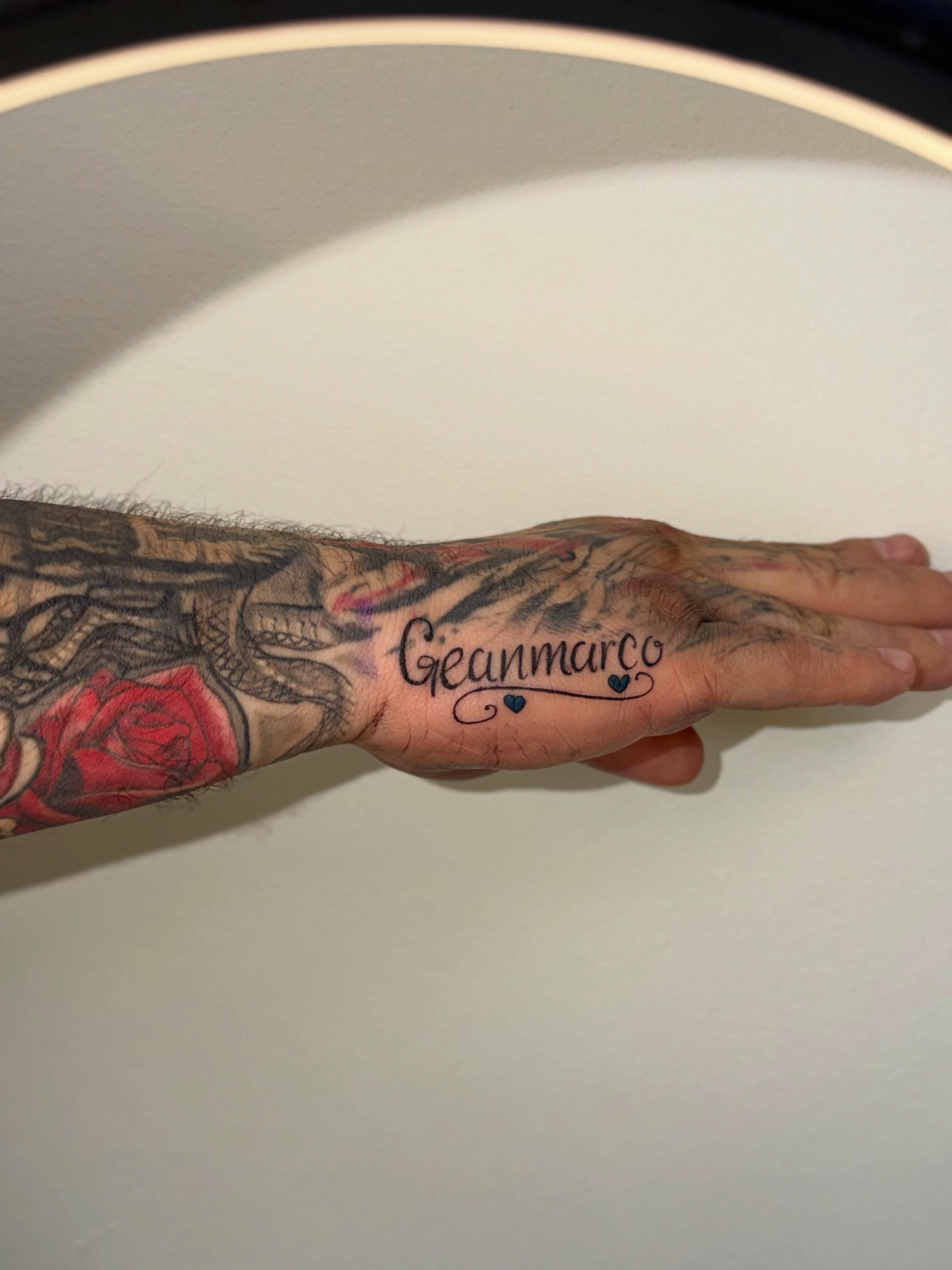 Gianmarco lettering script tattoo on the hand by Tatuajes Denver