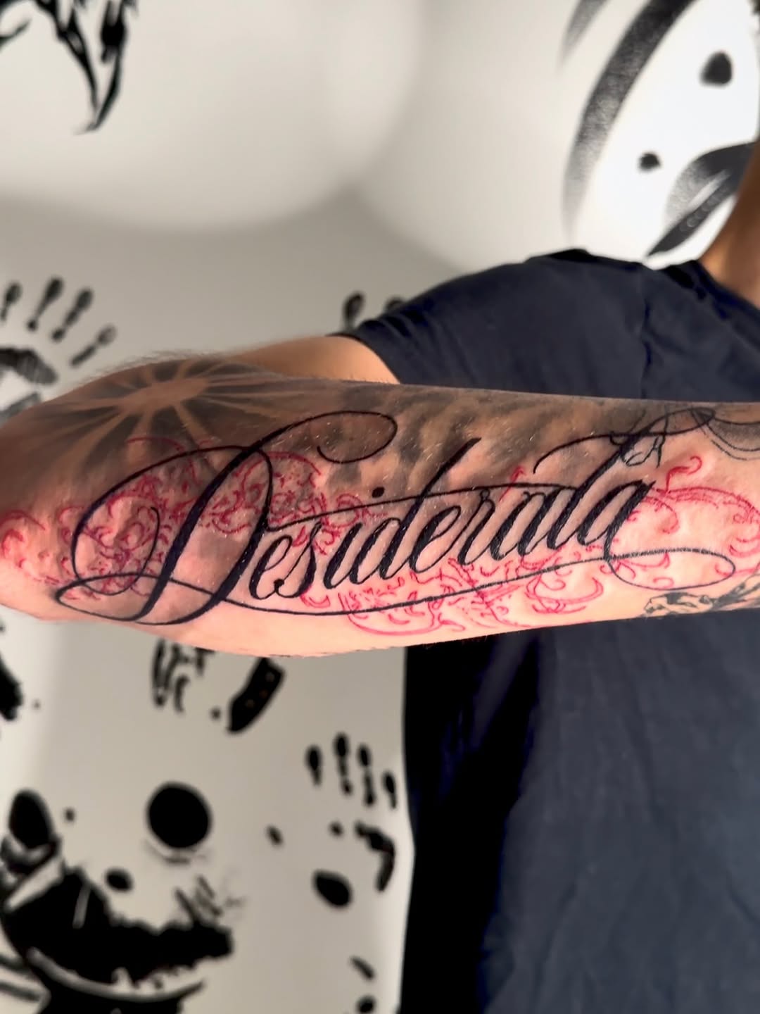 Desiderata lettering with ornamental background lettering tattoo on the forearm by K Valentine