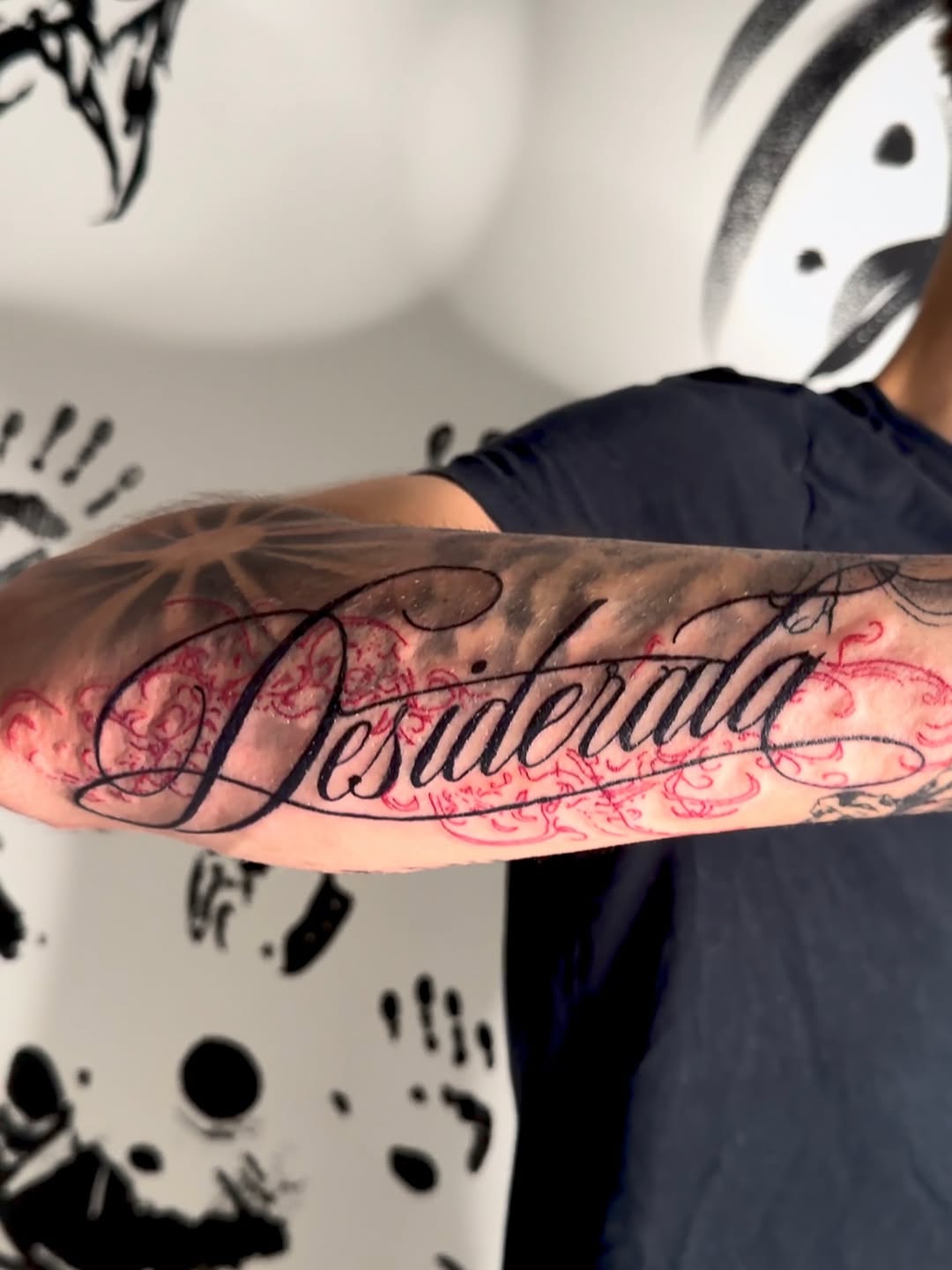 Desiderata script lettering with ornamental background lettering tattoo on the forearm by K Valentine
