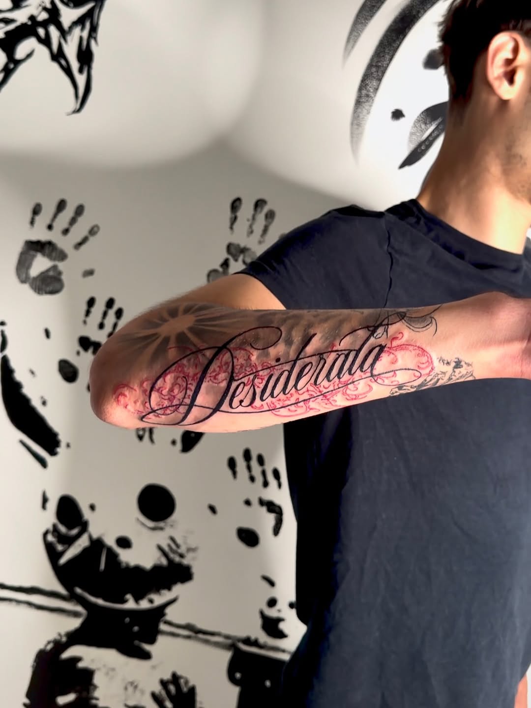 Desiderata script lettering with ornamental flourishes lettering tattoo on the forearm by K Valentine