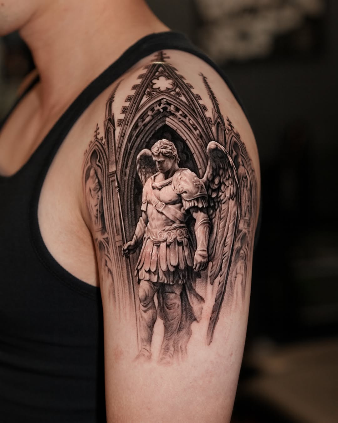 Angelic statue in gothic architecture realism tattoo on the shoulder by Gody