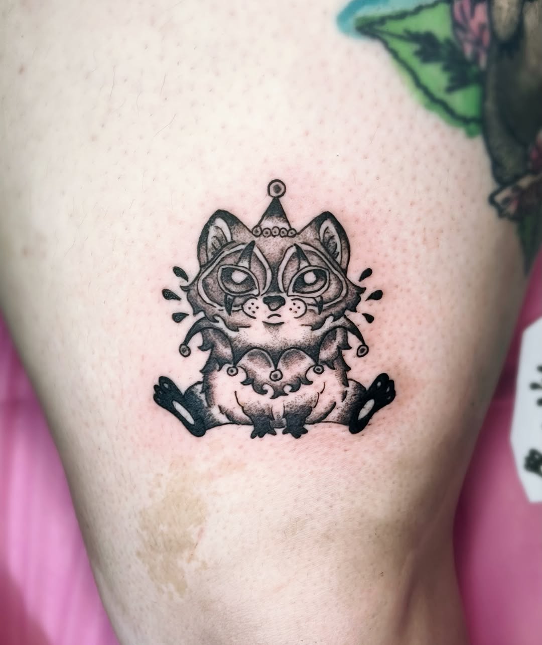 Clown raccoon realism tattoo on the thigh by Shay Cole