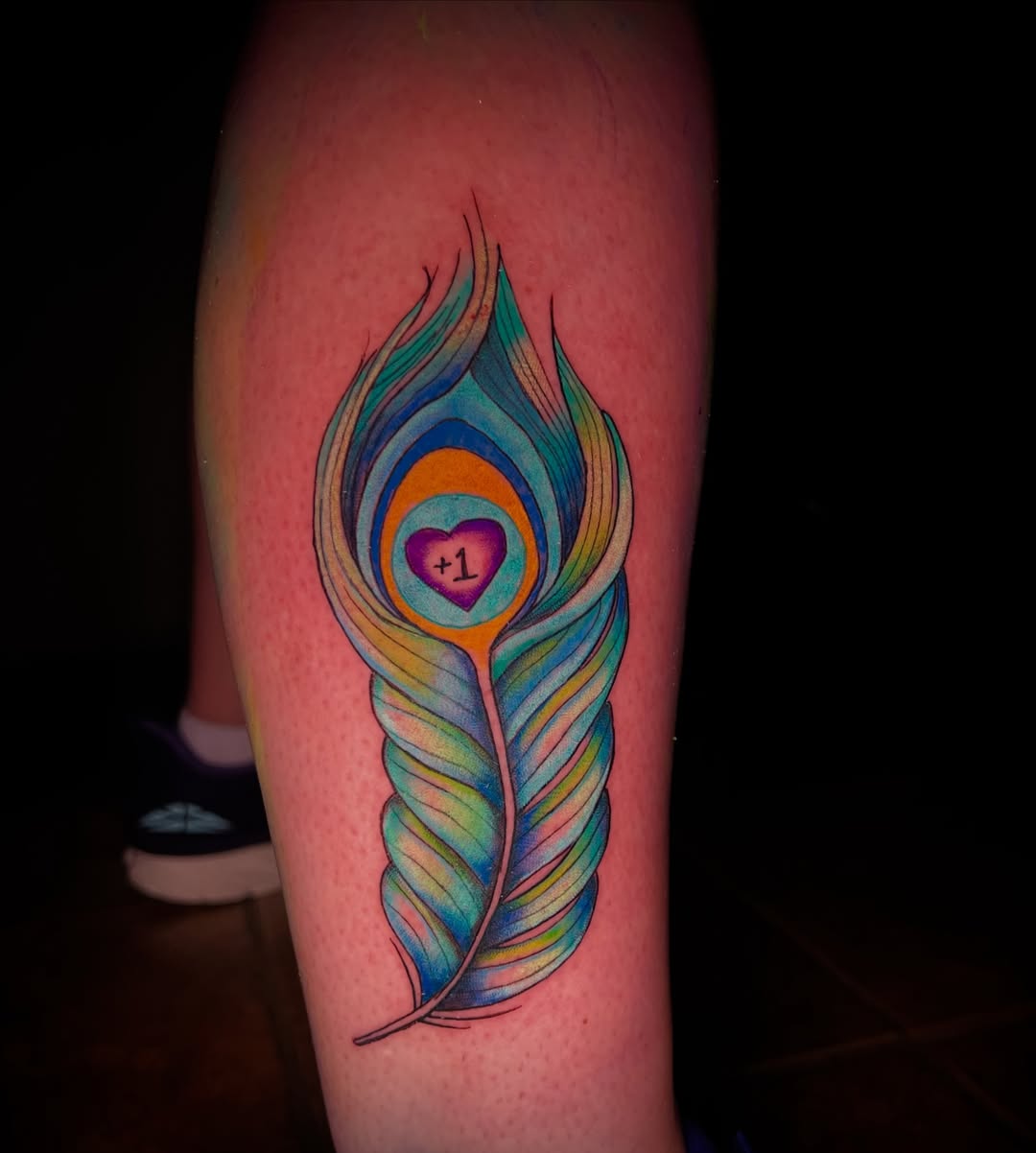 Peacock feather new school tattoo on the forearm by James Richardson