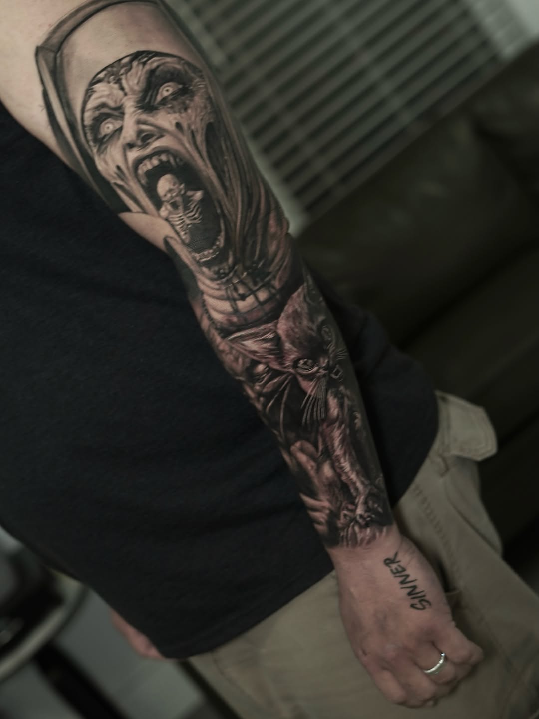 Screaming nun with skeleton, cat realism tattoo on the forearm by Nelson Tellez
