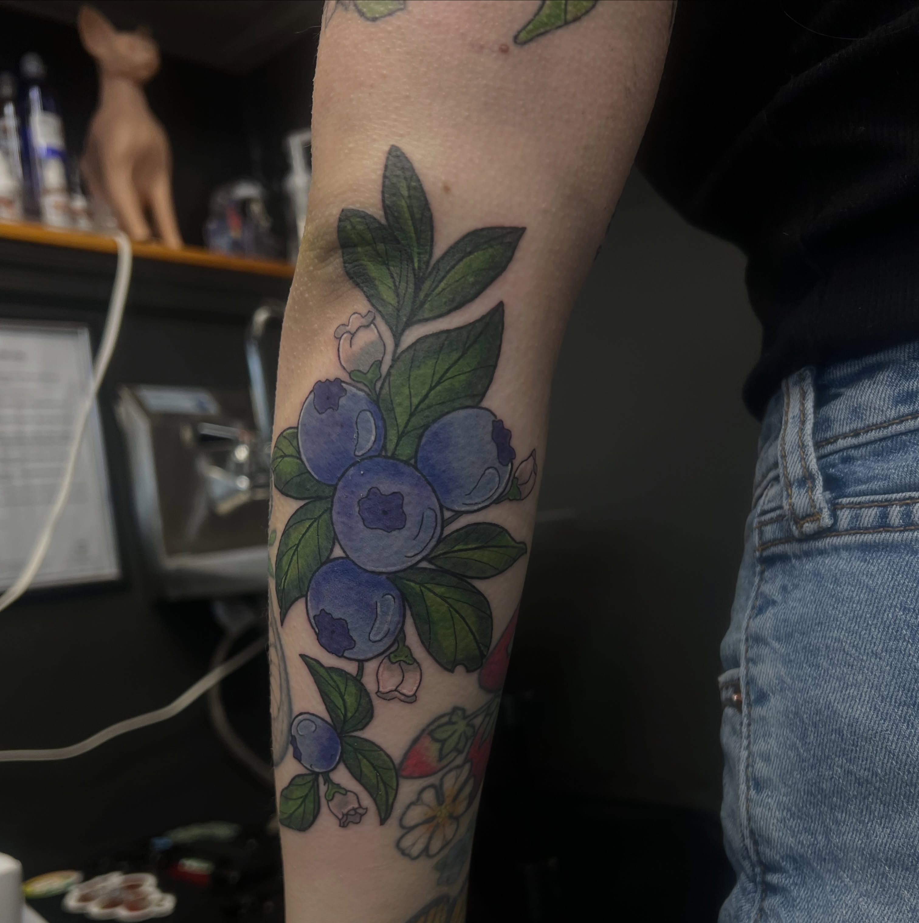 Blueberries realism tattoo on the forearm by Leslie Paskoff