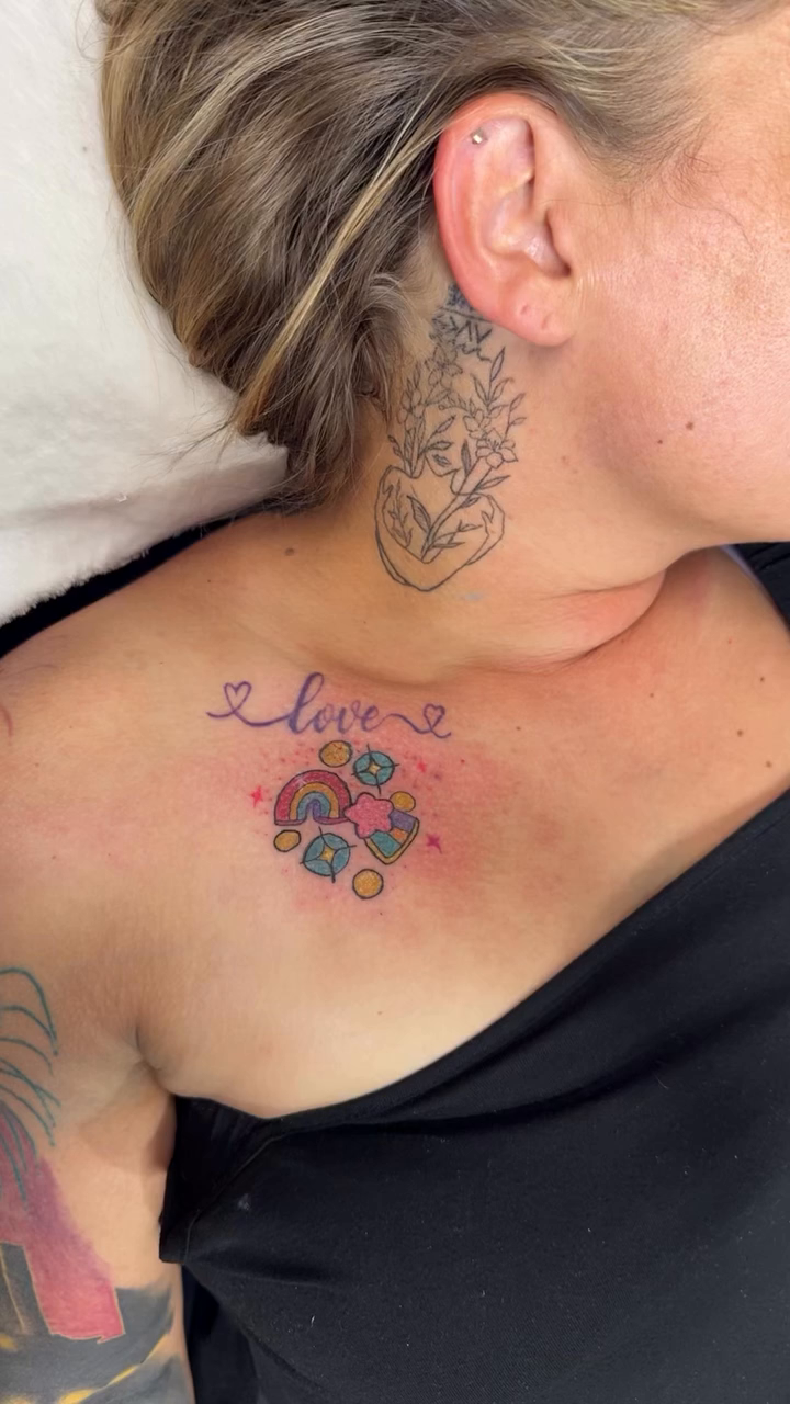 Love with rainbow and hearts watercolor tattoo on the chest by Felicia Lee, Des Moines, Iowa