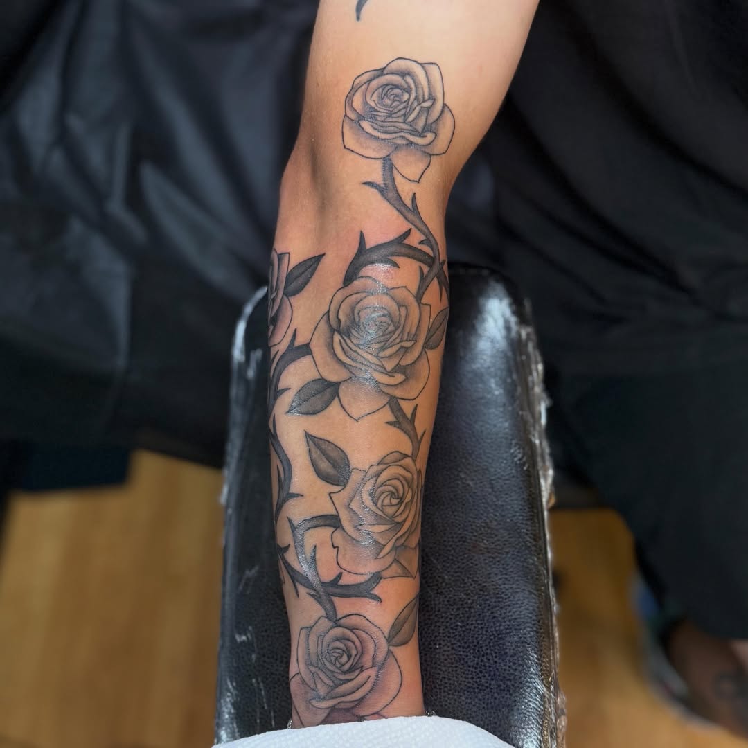 Roses black and grey tattoo on the forearm by Nic