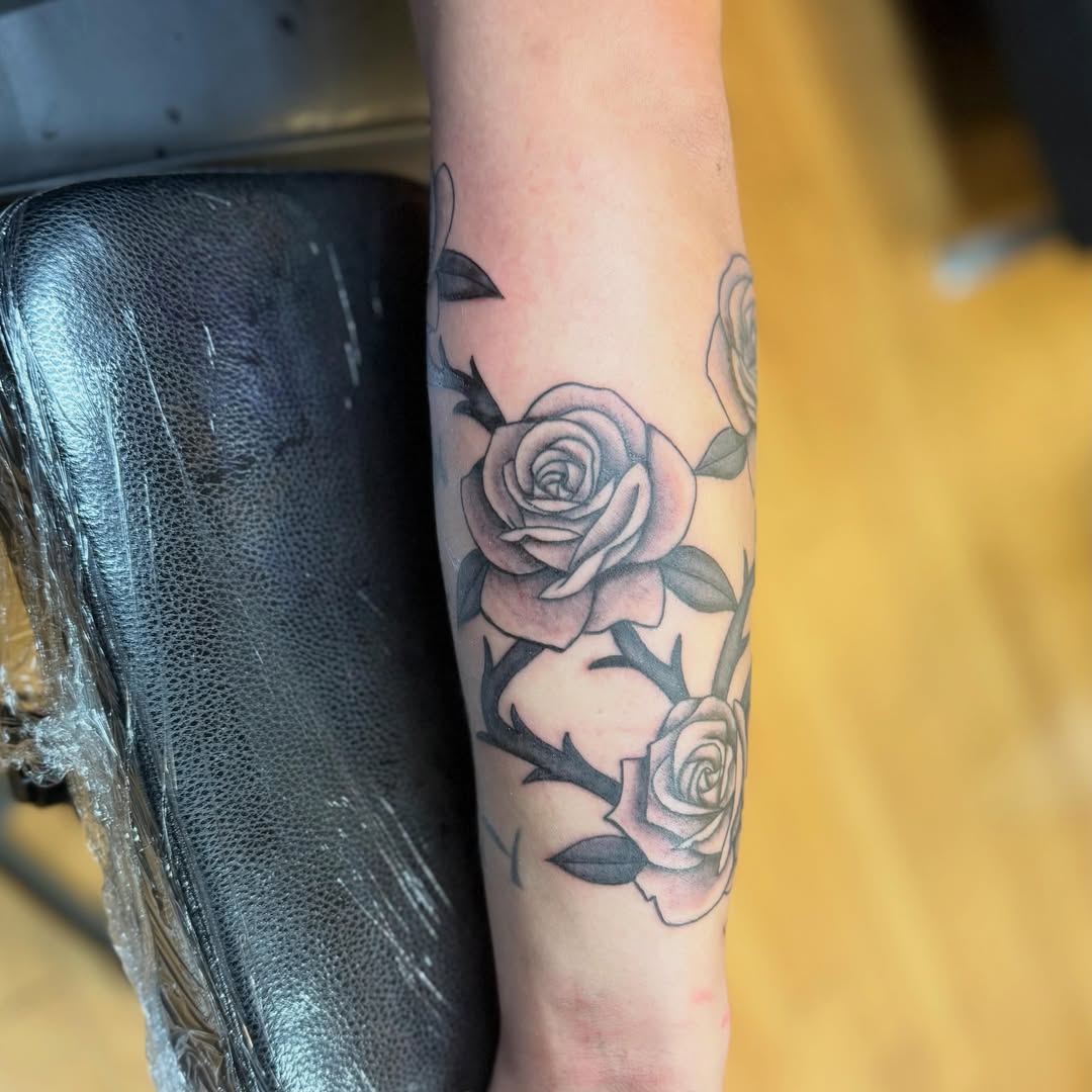 Roses black and grey tattoo on the forearm by Nic