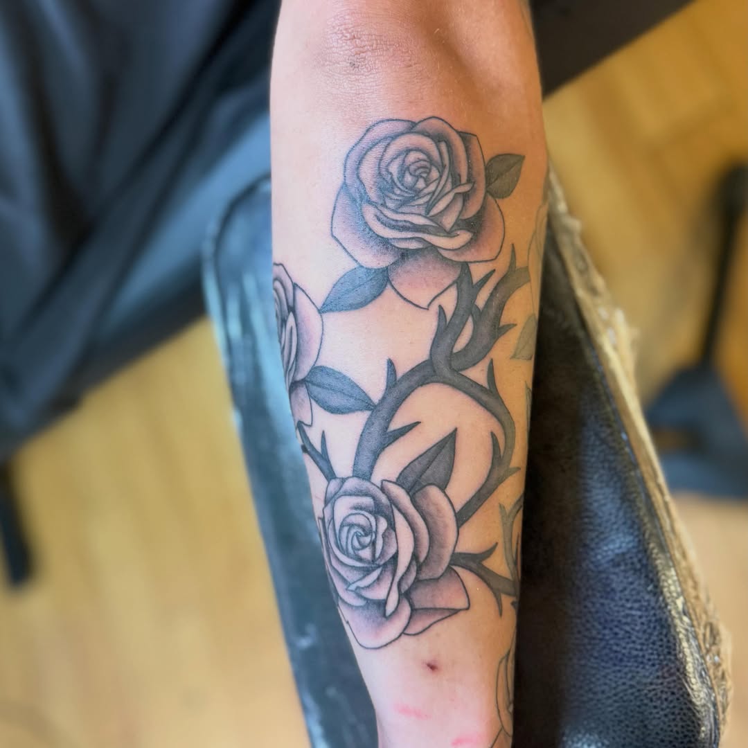 Roses black and grey tattoo on the forearm by Nic