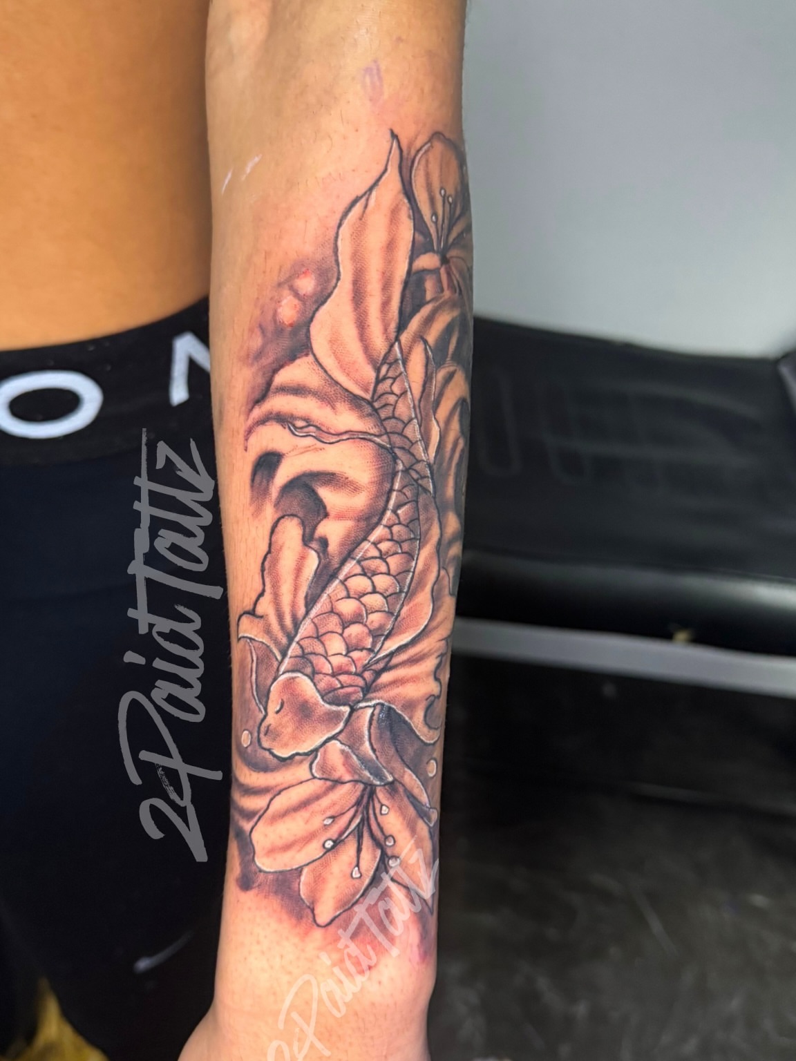 Koi fish and lotus realism tattoo on the forearm by 2PaidTattz