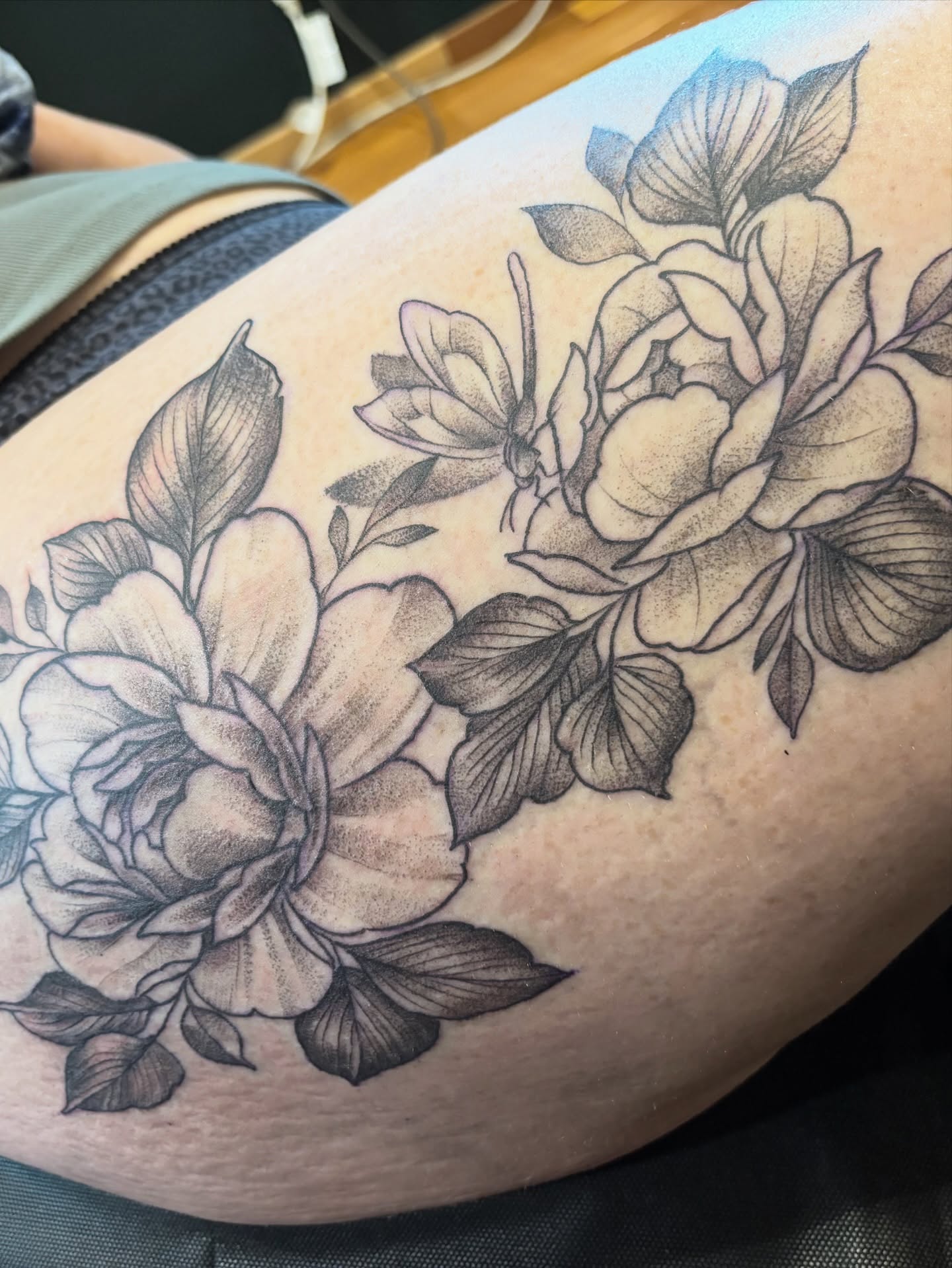 Peony flowers black and grey tattoo on the thigh by Komfort Kristy