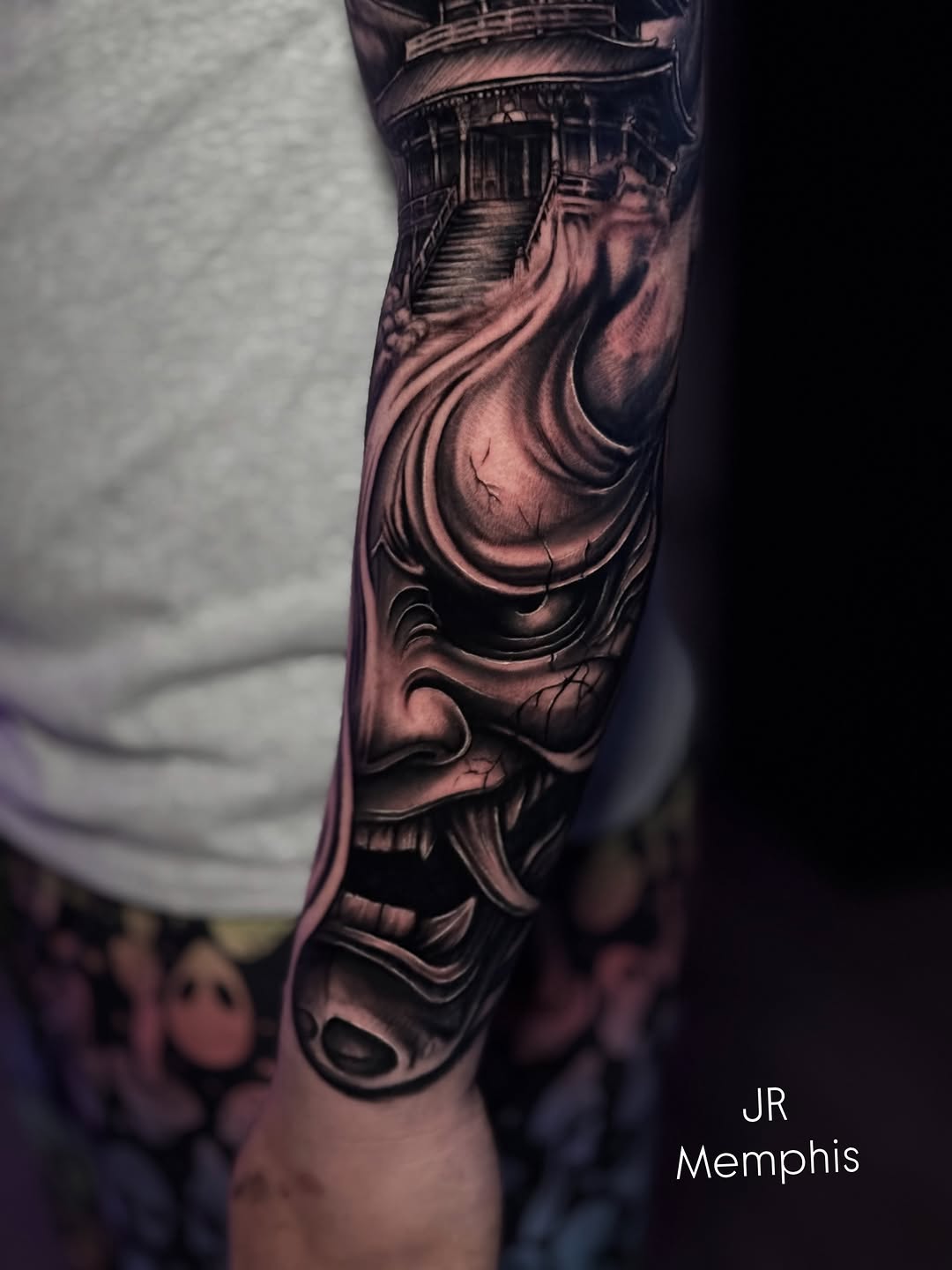 Oni mask and temple Japanese tattoo on the forearm by Juan Russo