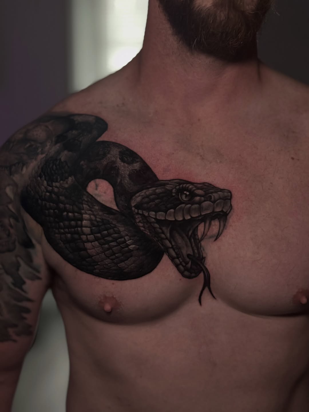 Snake realism tattoo on the chest by Juan Russo