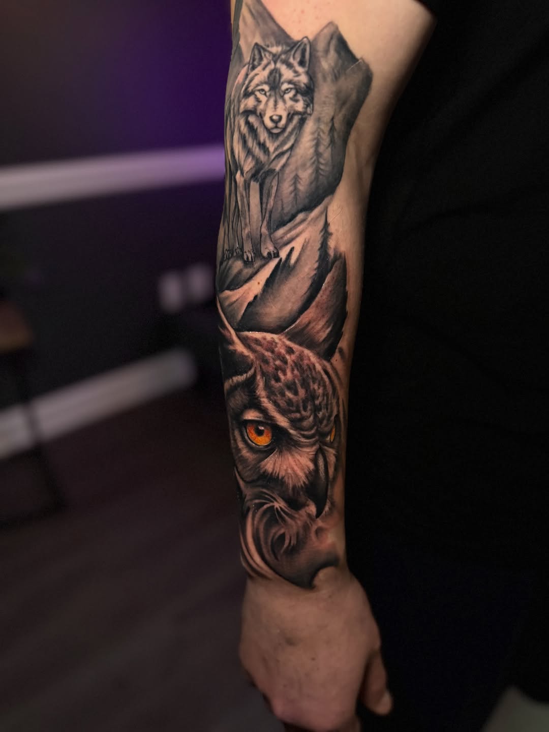 Wolf and owl realism tattoo on the forearm by Juan Russo