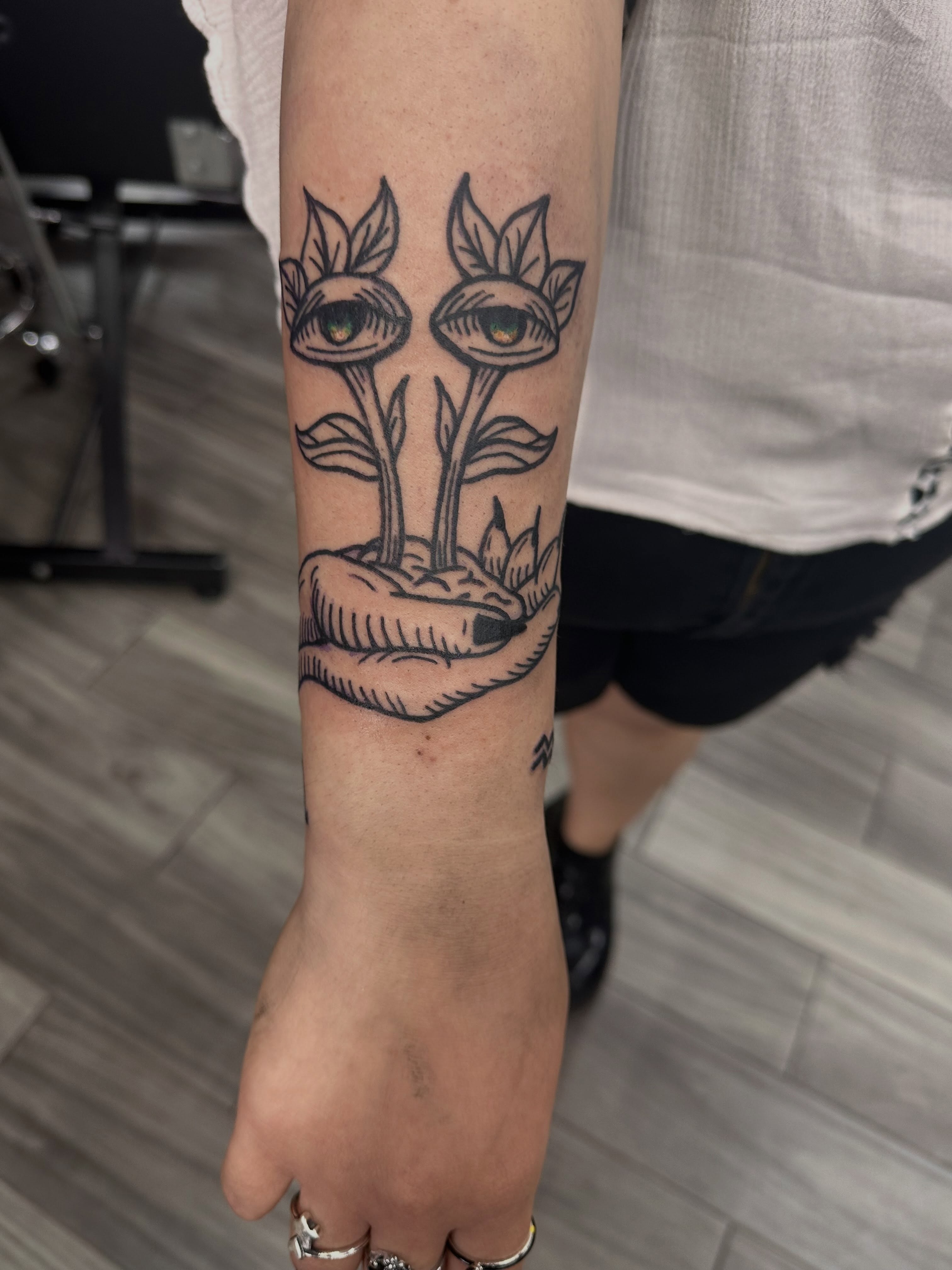 Eyes and flowers black and grey tattoo on the forearm by πΆππ ππππππ, Alamo, Texas