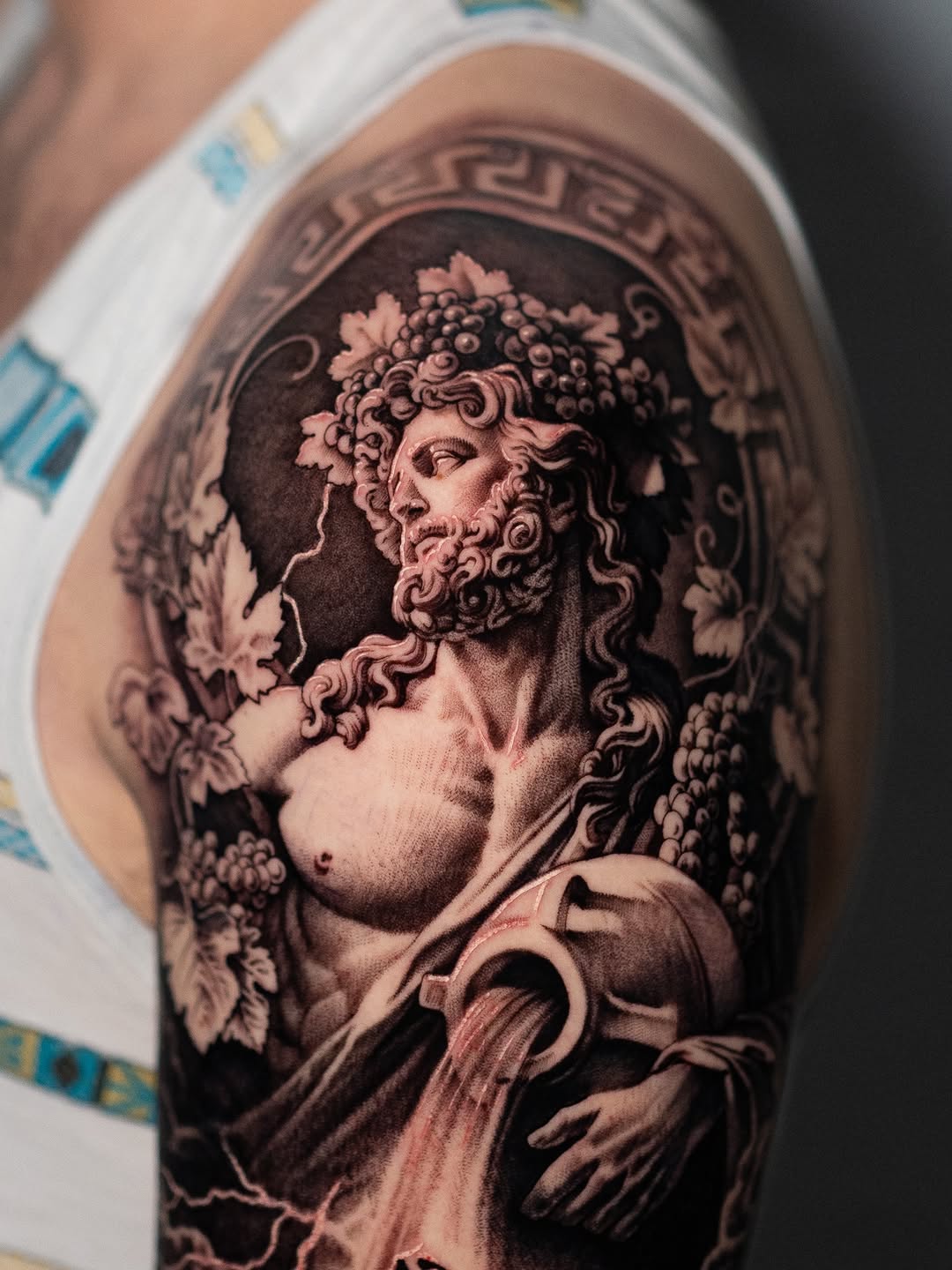 Bacchus pouring water realism tattoo on the forearm by Mark Vata