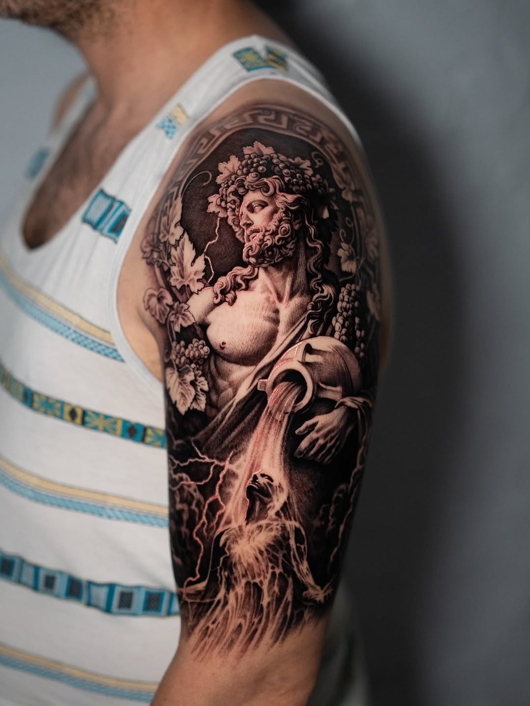Mythological figure pouring water realism tattoo on the forearm by Mark Vata