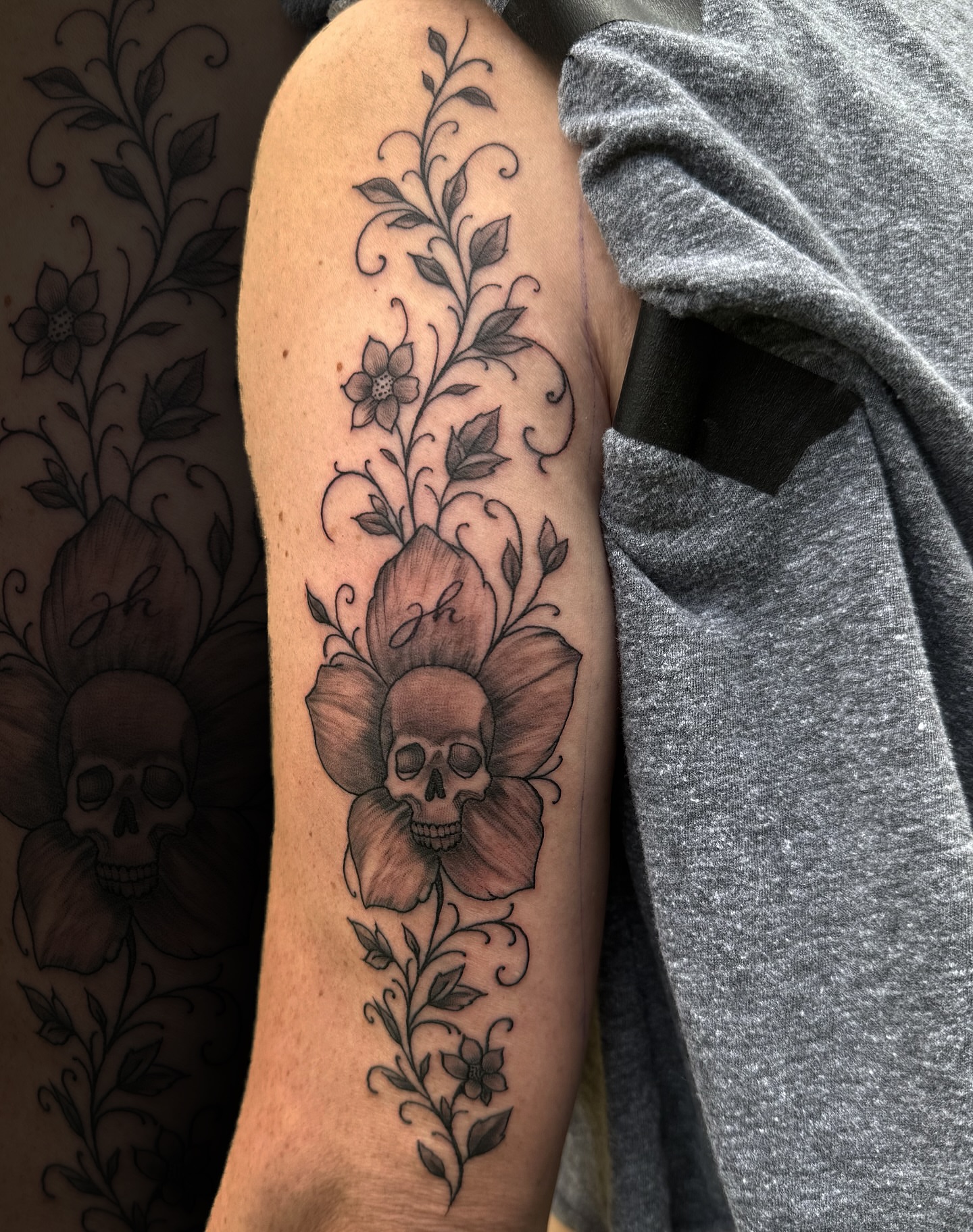 Skull and flower black and grey tattoo on the forearm by Nick Harrison, Dayton, Ohio