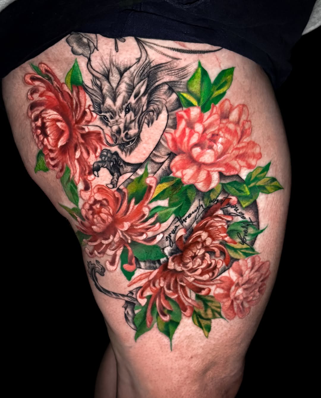 Dragon and chrysanthemums neo-traditional tattoo on the thigh by Jennifer Ramirez