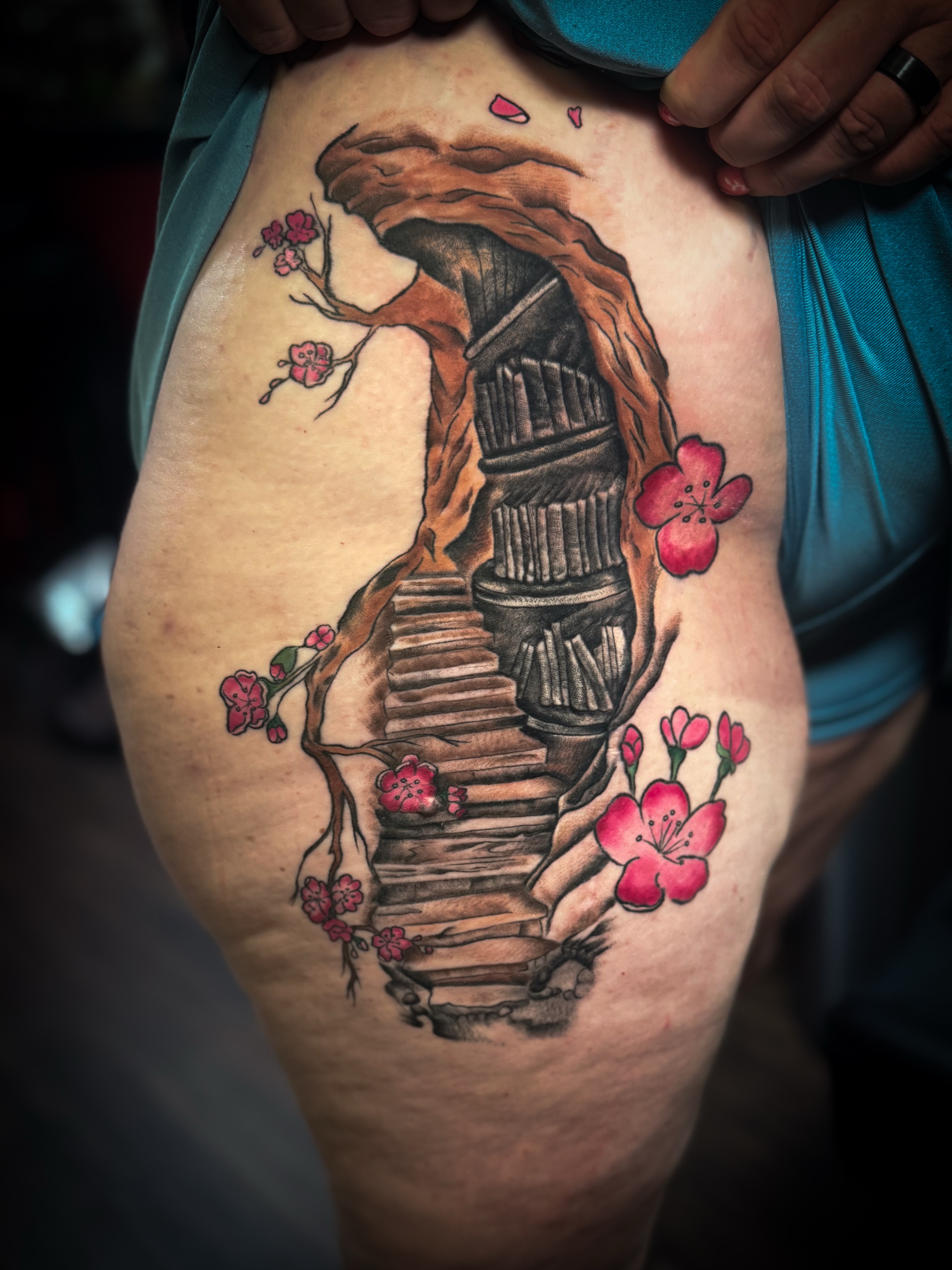 Staircase and cherry blossoms realism tattoo on the thigh by Jennifer Ramirez