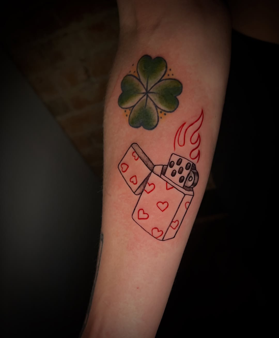 Four-leaf clover and lighter American traditional tattoo on the forearm by Saint