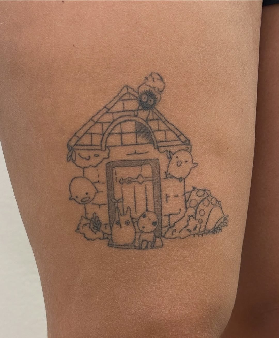 Ghibli characters house fine line tattoo on the thigh by Tattoo Takayo