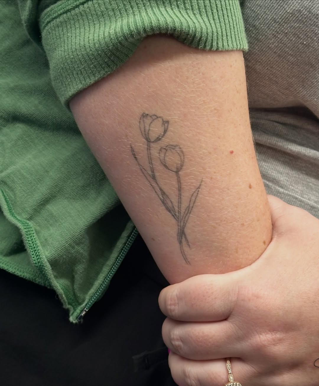 Two tulips fine line tattoo on the forearm by Tattoo Takayo