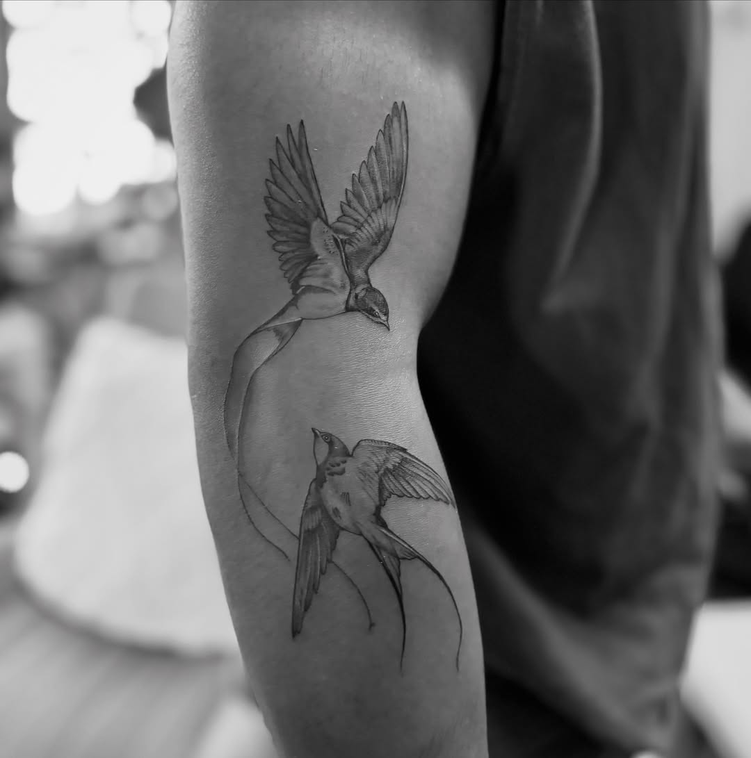 Swallows black and grey tattoo on the forearm by @secretlinetattoo