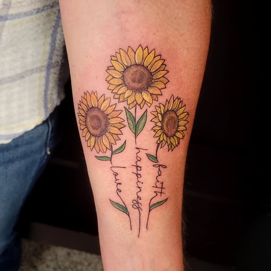 Sunflowers with words watercolor tattoo on the forearm by Sarah Alba