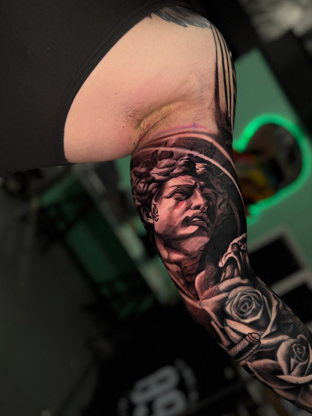 Bust of David with roses realism tattoo on the forearm by Danny Aceves ✨ San Diego tattoo artist