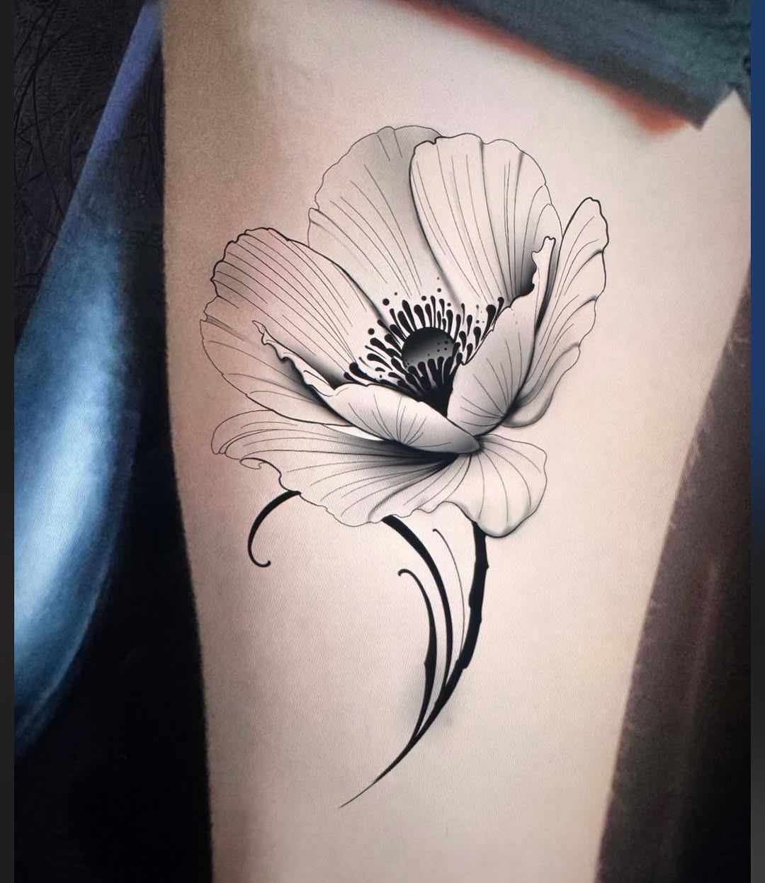 Poppy flower fine line tattoo on the thigh by David goldstein