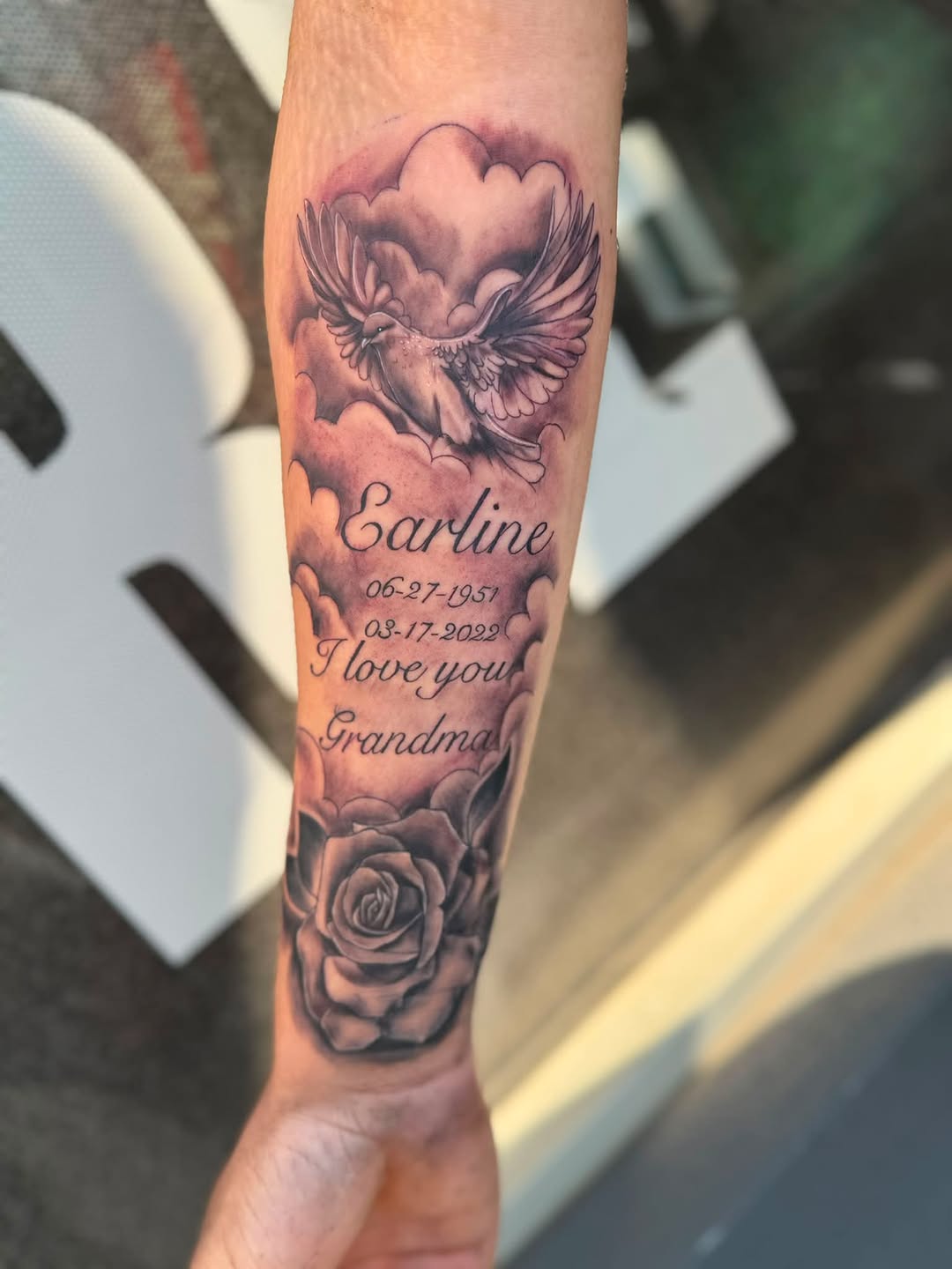 Dove, rose, and memorial text lettering tattoo on the forearm by Israel Jacob Woehler