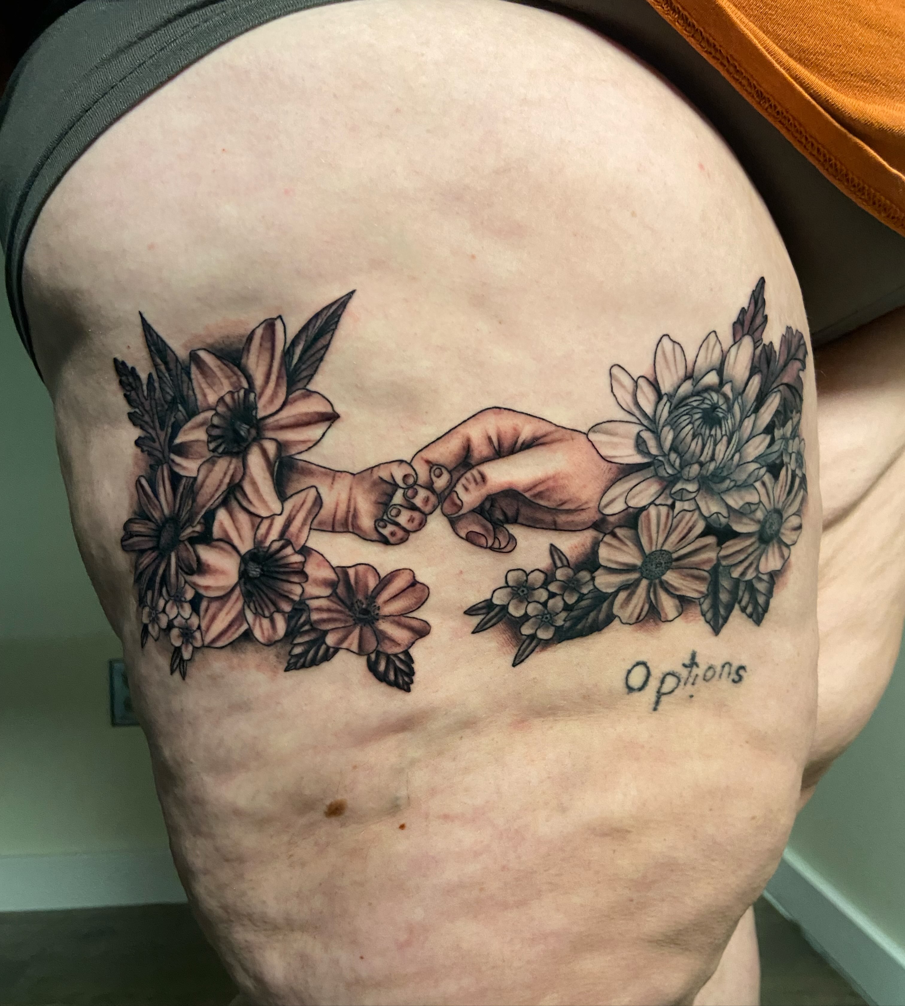 Finger touch realism tattoo on the thigh by Ezra Gonda