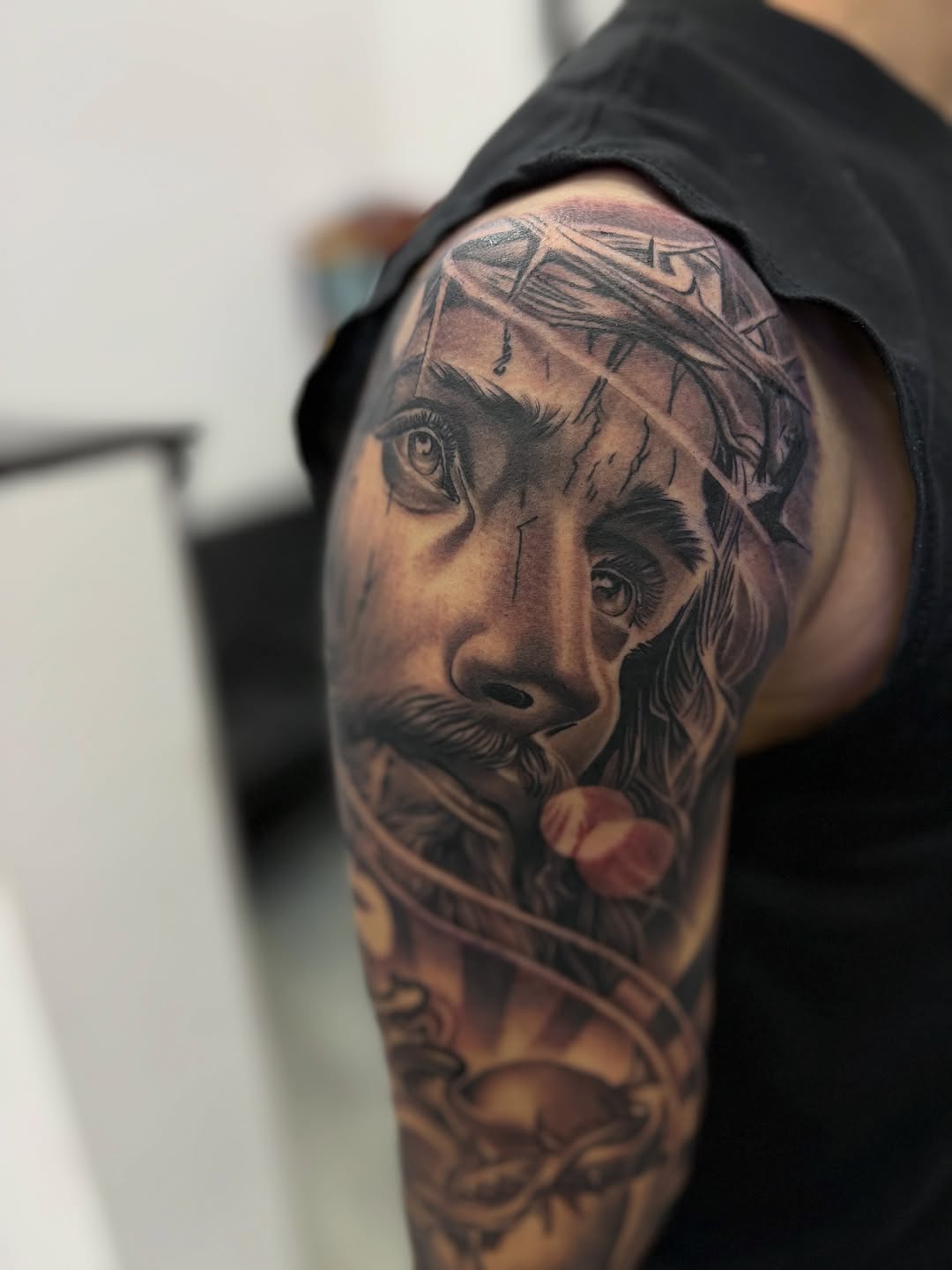 Jesus Christ portrait surrealism tattoo on the shoulder by Devin