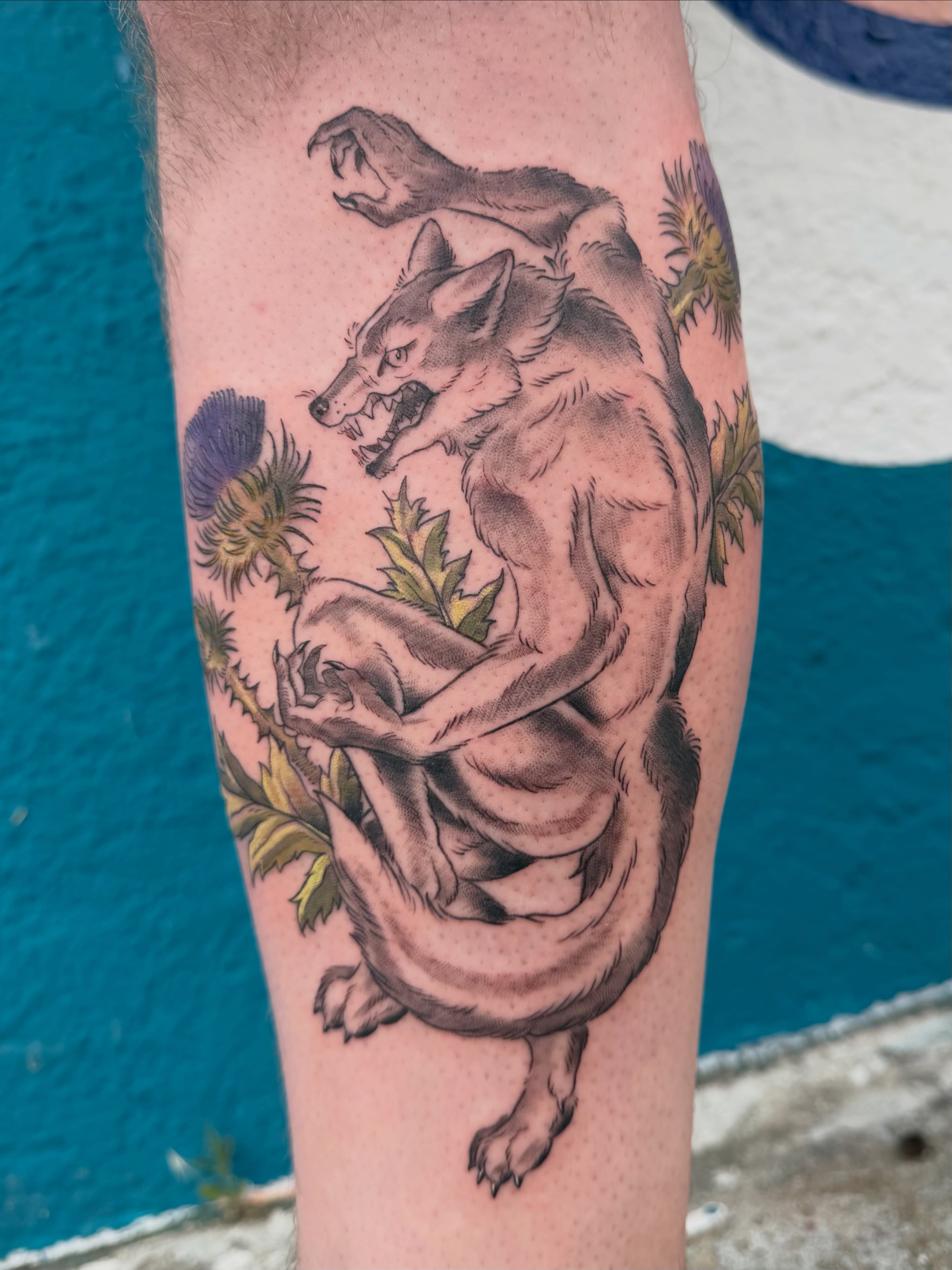 Wolf and thistle black and grey tattoo on the forearm by Roswell Orellana 👽🛸