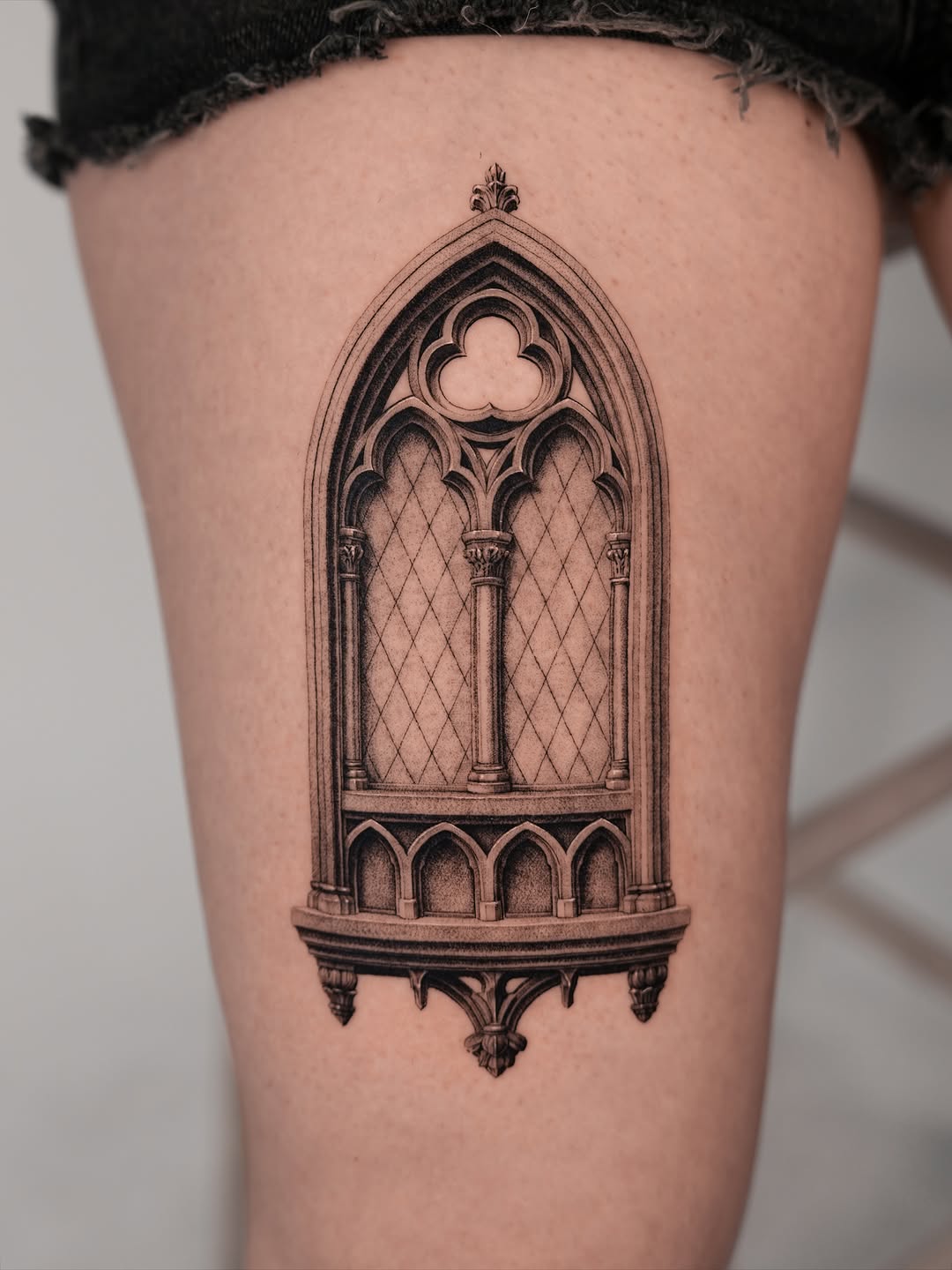 Gothic window dark art tattoo on the thigh by Jun