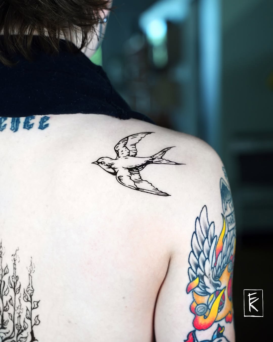 Swallow bird fine line tattoo on the shoulder by elizaveta