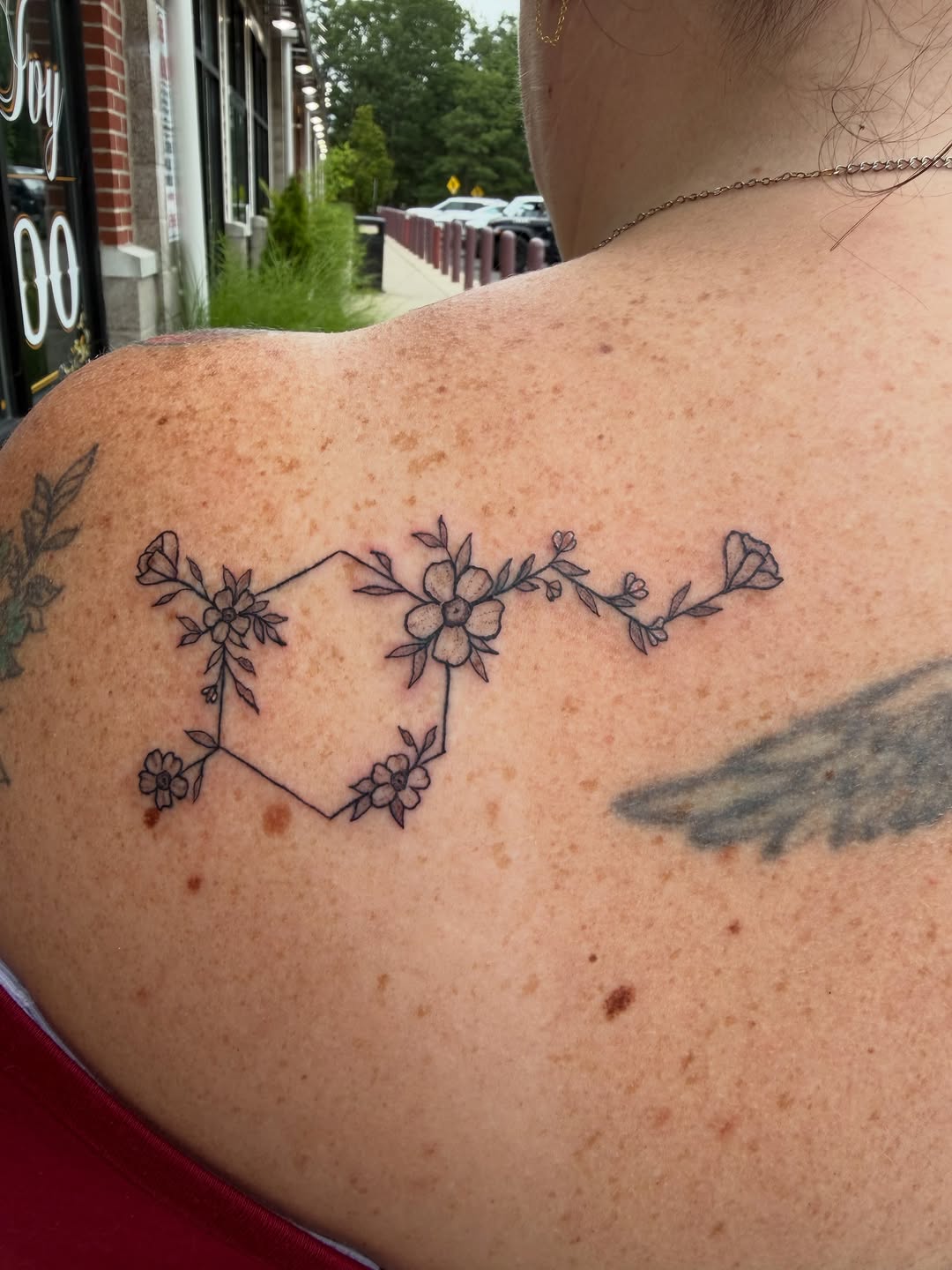 Geometric constellation with flowers tattoo on the back by K. Bel Art